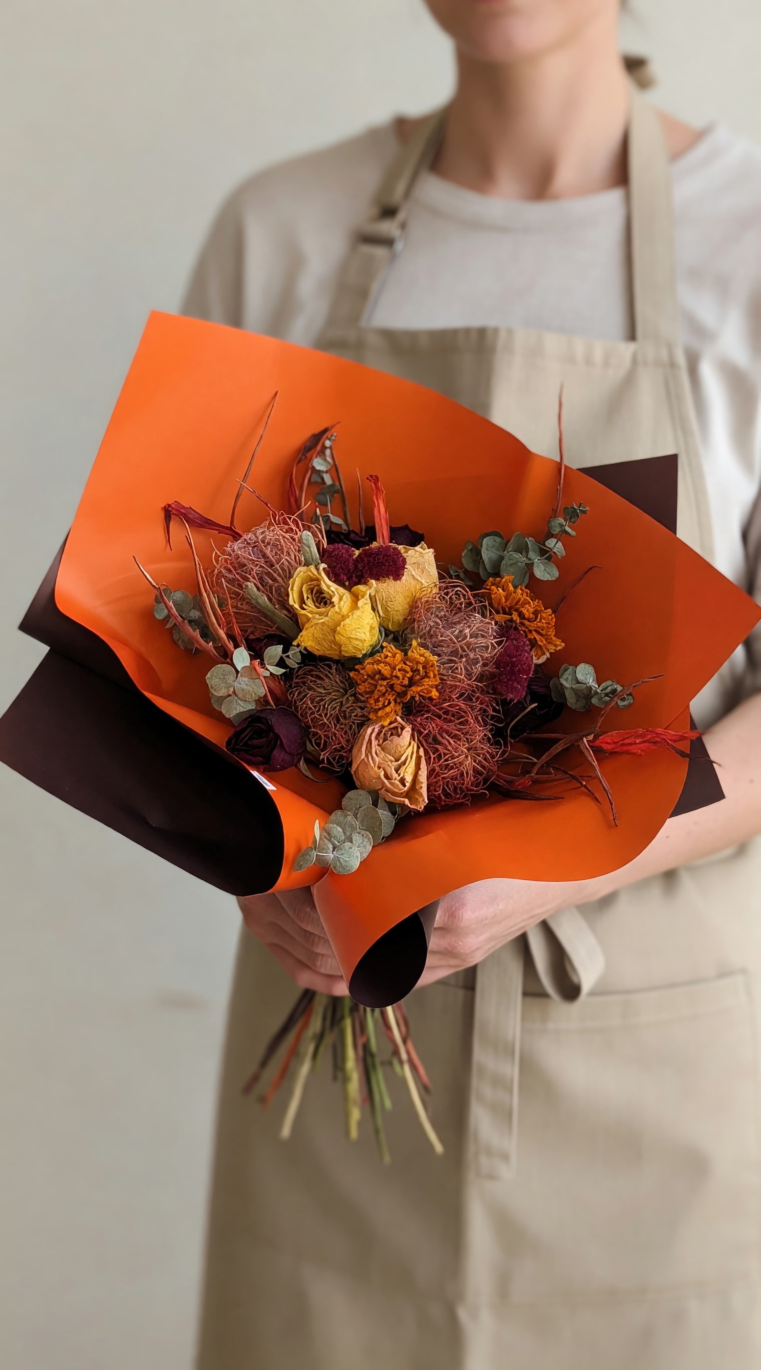 Autumn Harvest Dried Bunch - A compact, rustic bunch of dried blooms in warm autumn tones-this dried flower bouquet is perfect gift that feels both modern and timeless. The mix of yellow and burgundy rose heads with orange, blooms creates a rich, textured center that makes the recipient feel genuinely seen-ideal for anniversaries, birthdays, or a thoughtful "thinking of you" surprise.