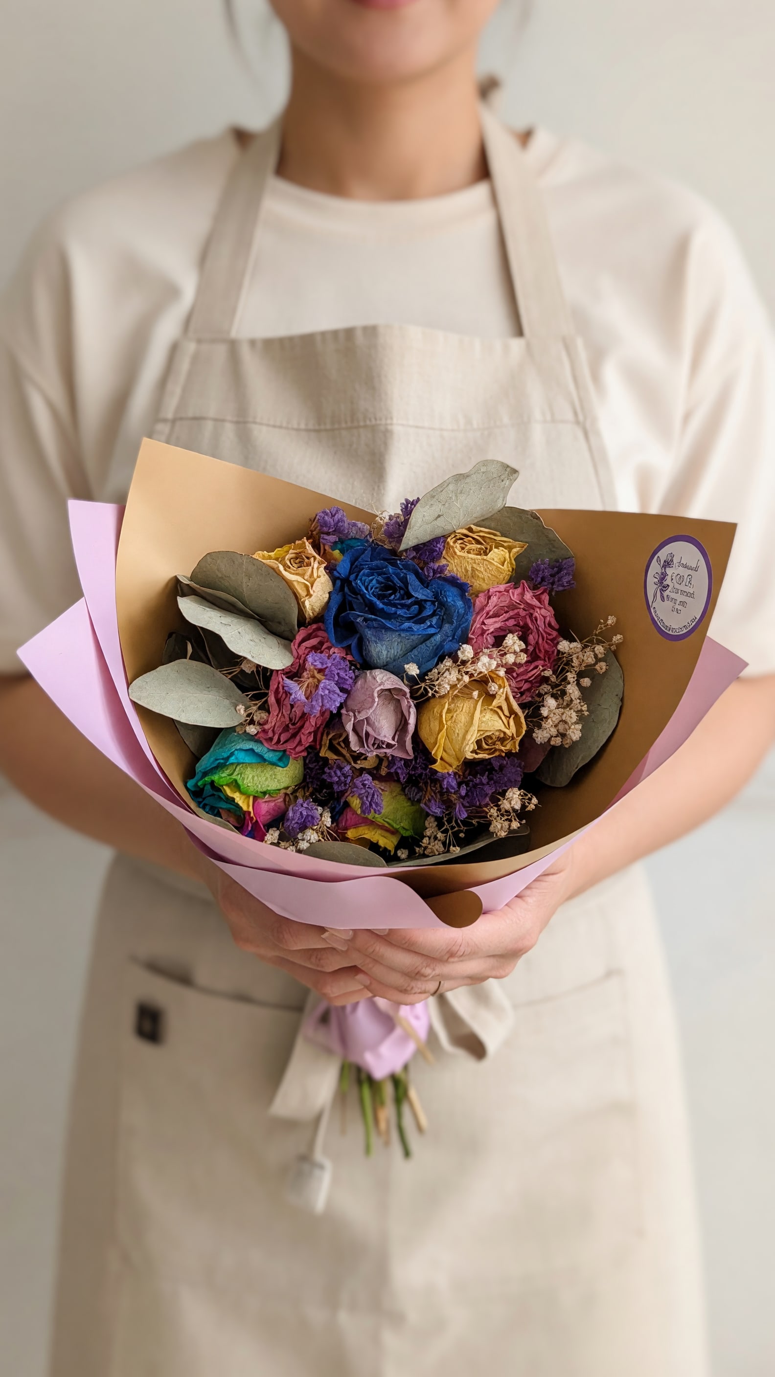 Tie Dye Ain't Gonna Lie Dried Bouquet  - A vivid cluster of dried roses that reads like wearable art-this Tie Dye Ain't Gonna Lie dried bouquet is a mixed-color flower bouquet is perfect for birthdays, anniversaries, or a cheerful "just because" surprise. The centerpiece is a striking bright blue rose surrounded by pink, purple, yellow, and green-toned blooms, creating a joyful tie-dye effect that makes the recipient feel truly celebrated without fuss.