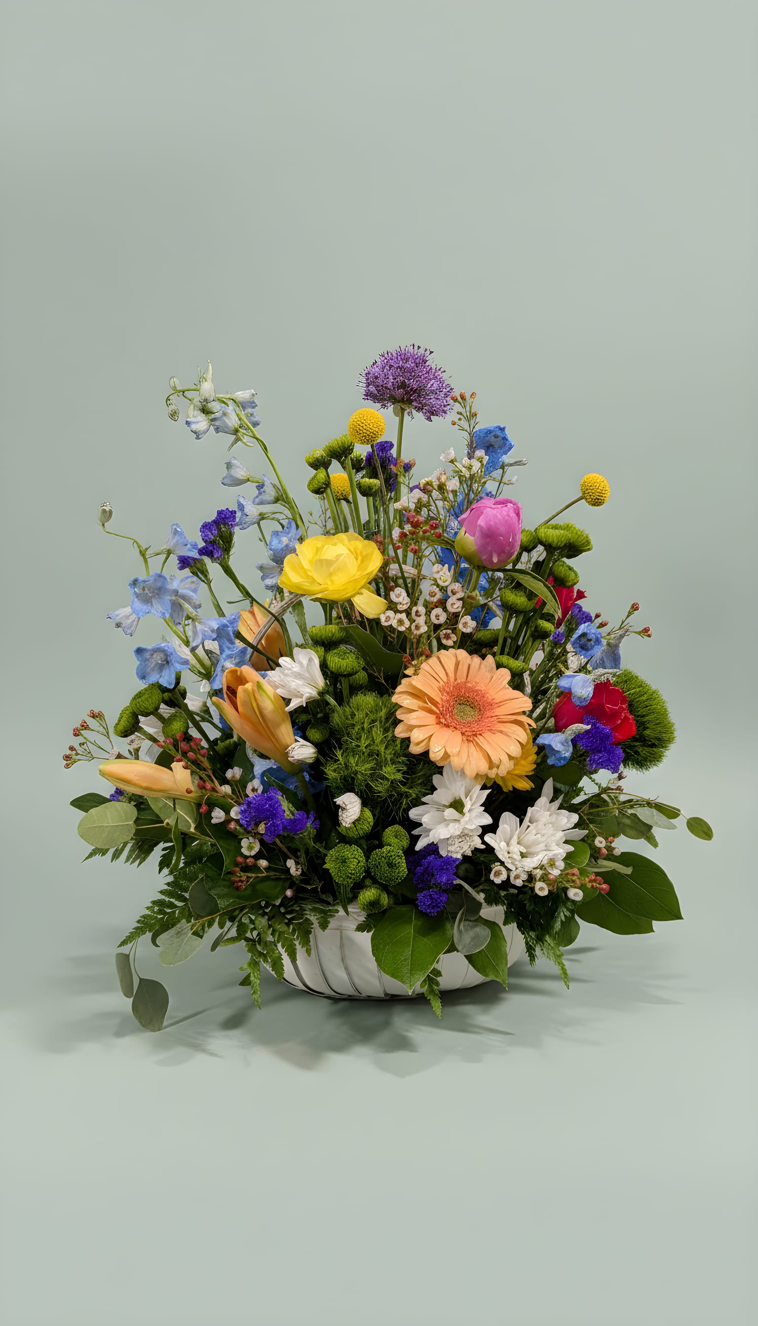 Designers Choice in a Basket - Assorted flowers in a basket All Around Arrangement Height and Width Vary 