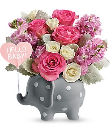 Pink and white flower arrangement in a gray elephant planter with a Hello Baby sign