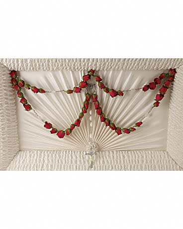 White casket with red rose garland