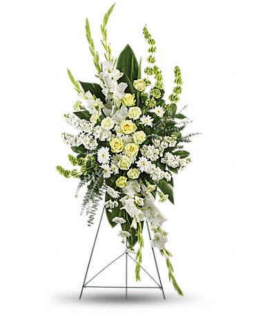 Standing floral spray of white and pale yellow flowers on an easel