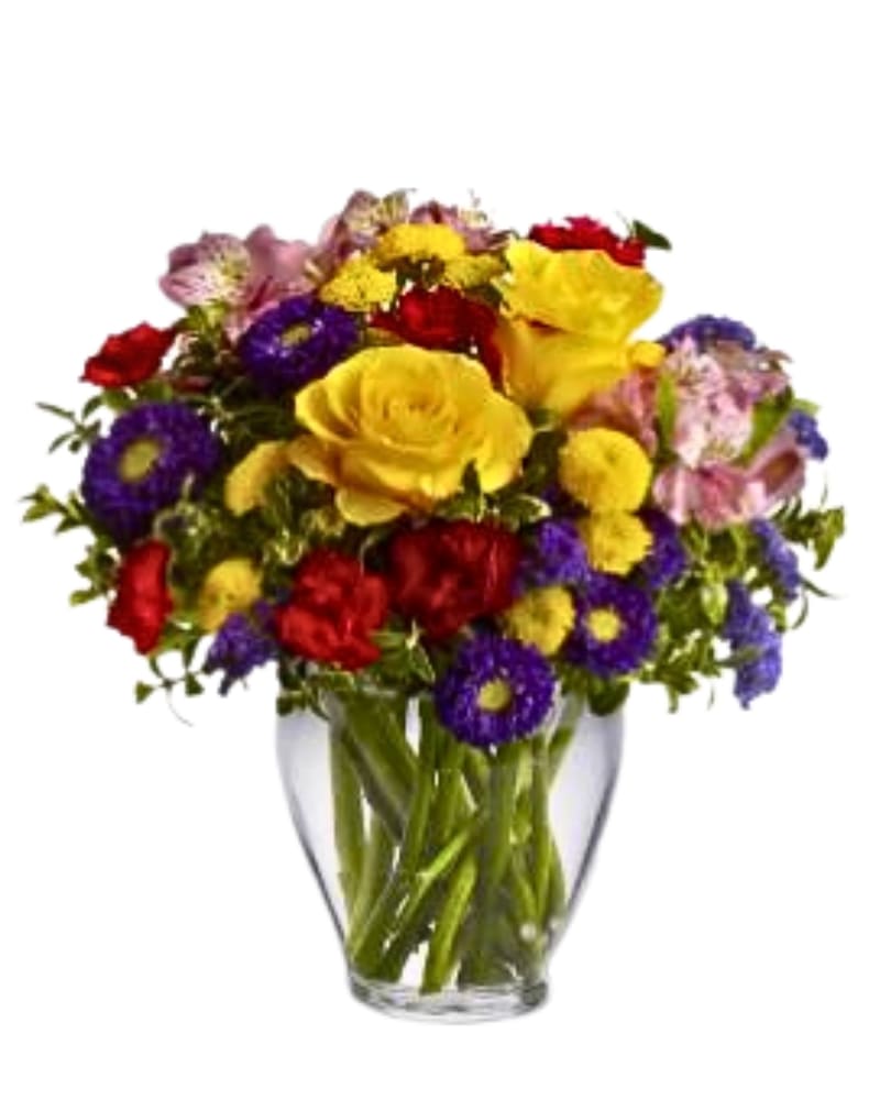 Mixed bouquet of yellow, red, purple, and pink flowers in a clear glass vase