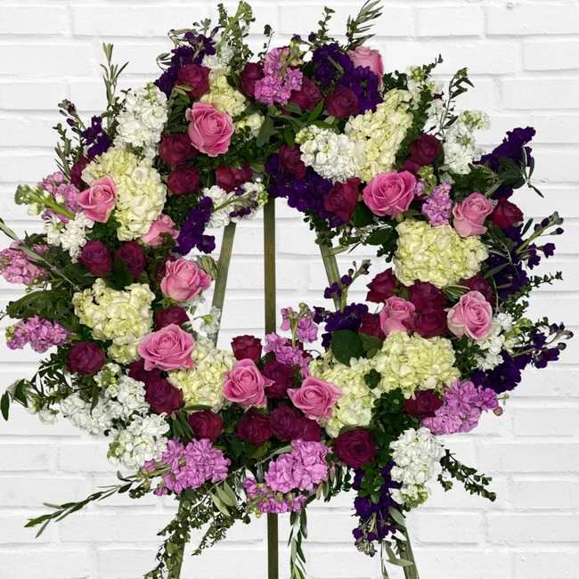 Heart-shaped floral wreath with pink, purple, and white blooms