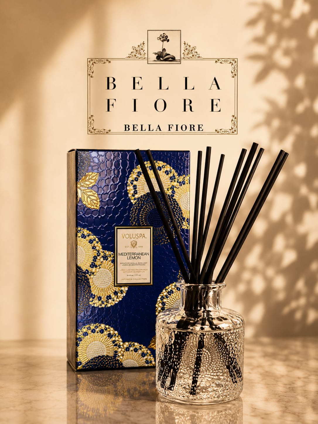 Reed diffuser in a clear glass bottle with a decorative blue box