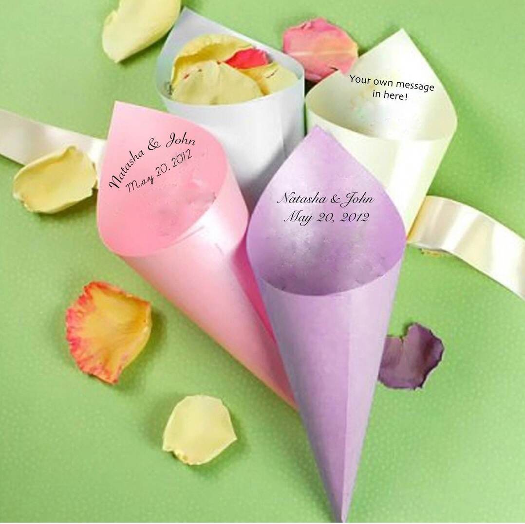 Pastel paper cones holding rose petals on a green background