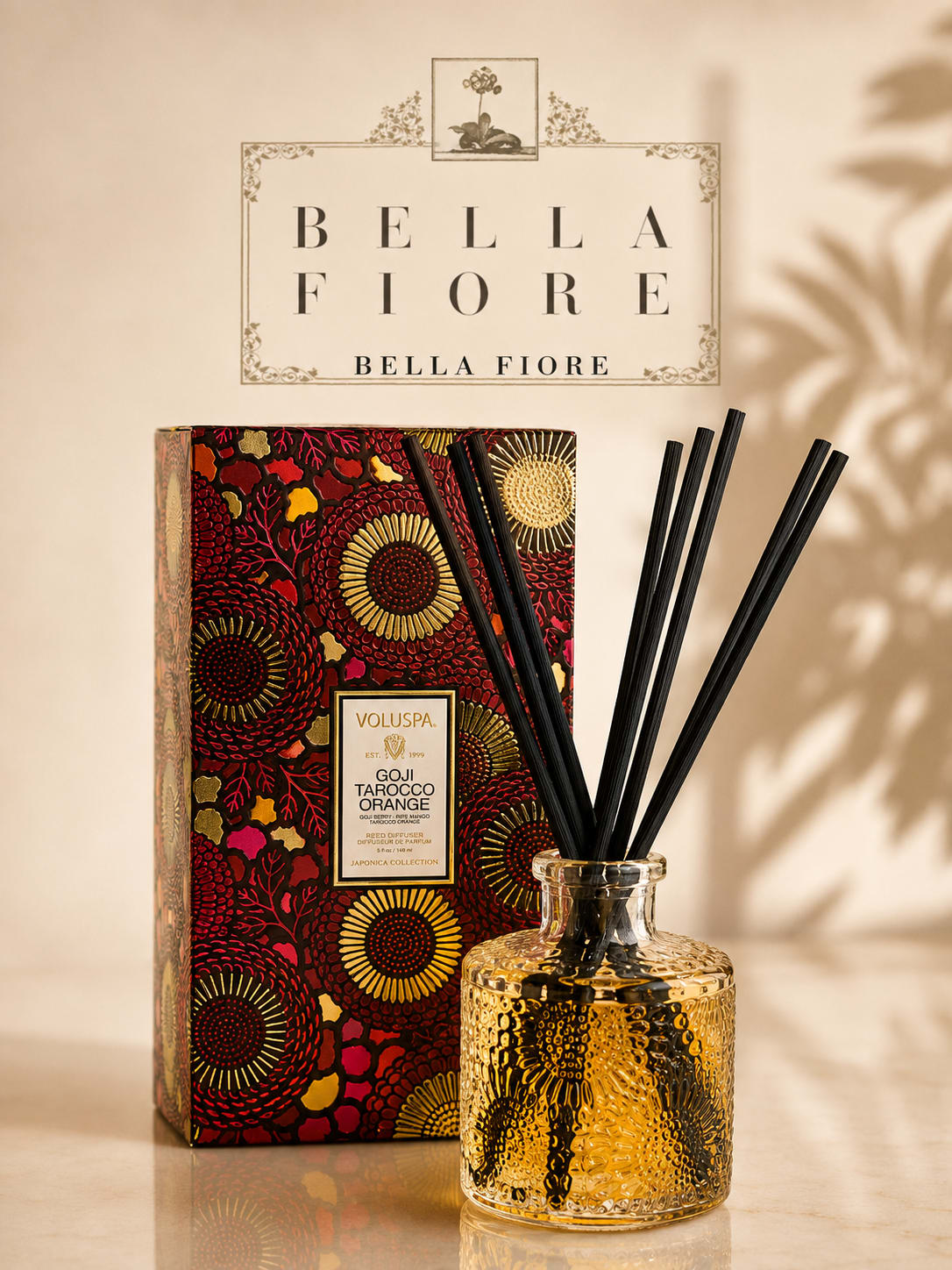 Decorative reed diffuser in a textured glass bottle with a patterned box