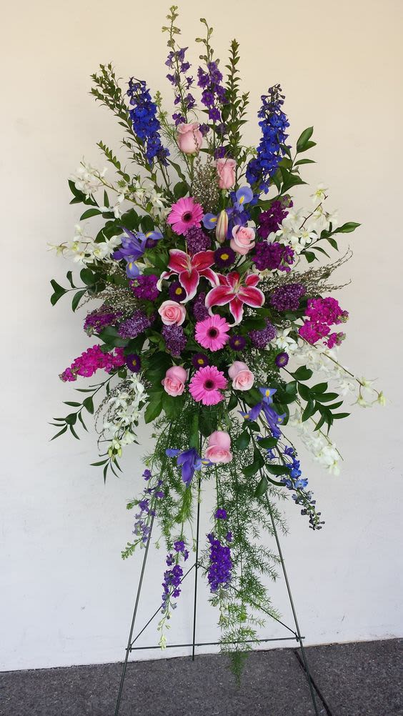 Tall standing floral spray with pink, purple, blue, and white flowers