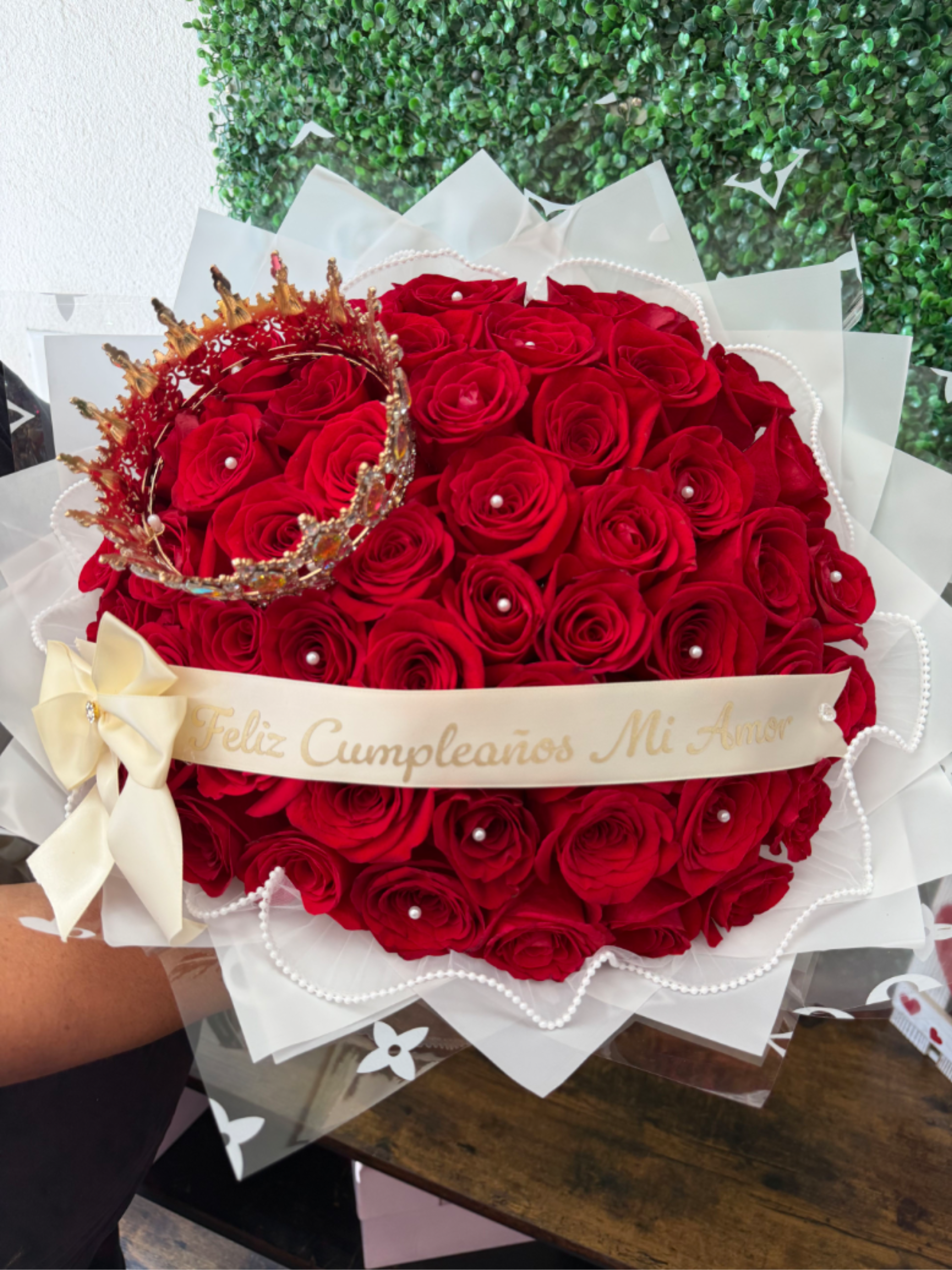 Royal romance - A luxurious arrangement of red freedom roses, complemented with a jeweled crown and delicate pearls, fit for the queen In your life.