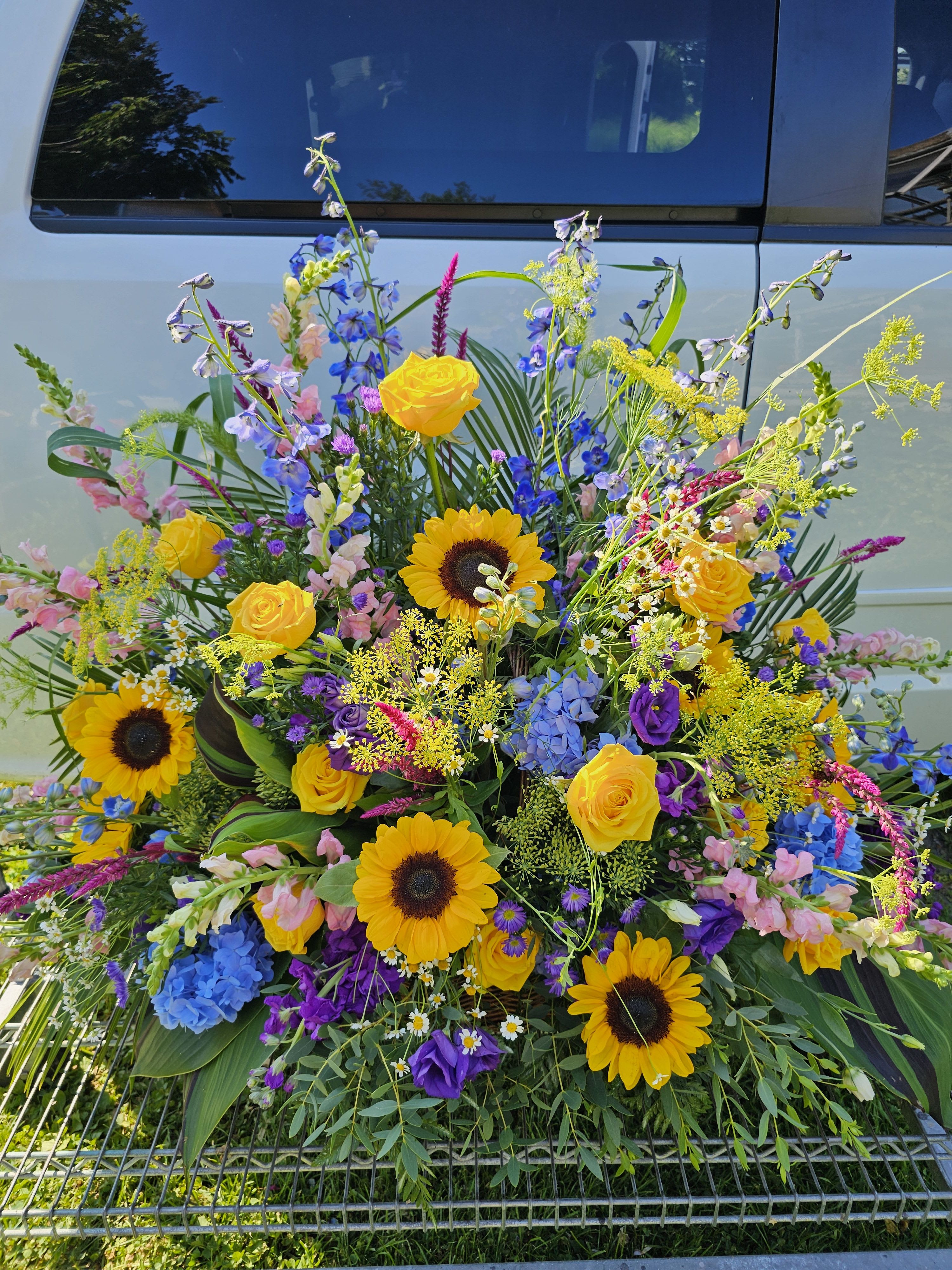 Signs of summer tribute Basket - Sunflowers,delphinum,yellow roses,purple liatris and blue hydrangea are a beautiful celebration of life basket
