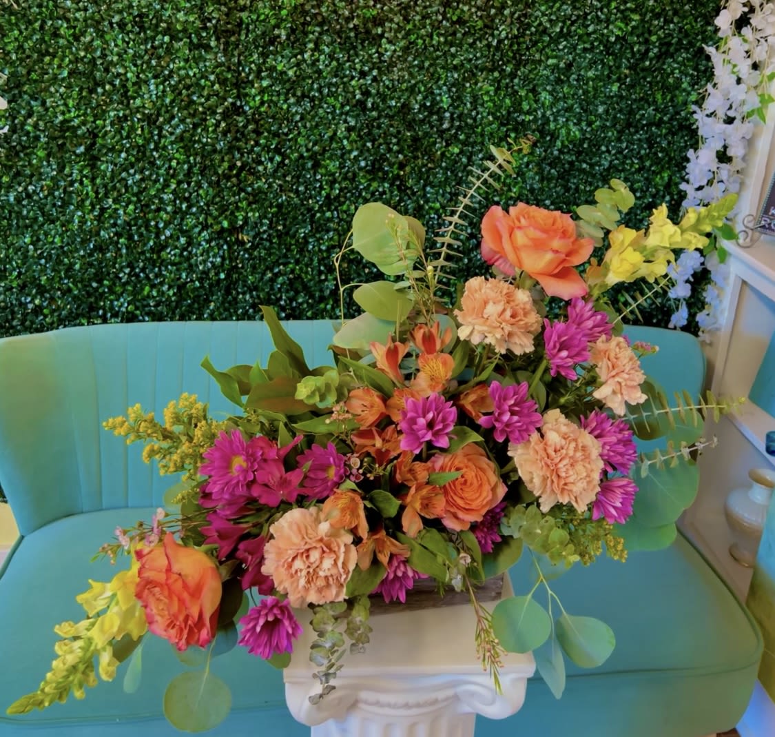 Phoenix Sunset - An A-symmetrical sunset themed floral arrangement that compliments our phoenix sunset sky. Flowers may be different from the picture that are shown but the theme will still be sunset.  Bring the sunset inside your home.