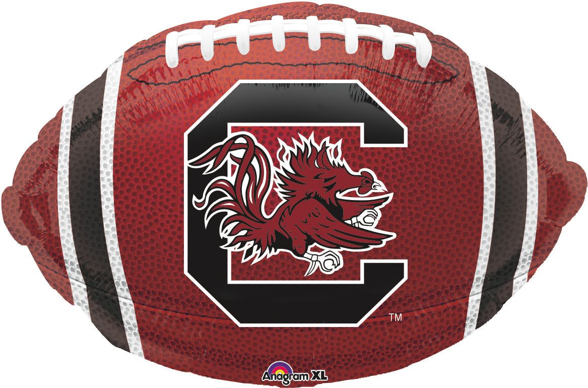 18" Carolina Gamecocks Football Mylar - Make any Gamecock fan feel celebrated with this 18" Carolina Gamecocks football-shaped Mylar balloon-perfect for game-day gifts, tailgates, or a college birthday surprise. The sporty, collegiate look features a bold South Carolina Gamecocks logo front and center, with deep red, black, and white paneling, printed laces, and stripe details that read clearly from across the room.  This foil balloon measures 18 inches across and holds helium or air for table displays, party décor, or to top a gift arrangement. It pairs easily with red and black floral accents or can stand alone as spirited décor for a dorm room or watch party. Order with confidence for same-day delivery options to make the person you're thinking of feel like the MVP of the celebration.