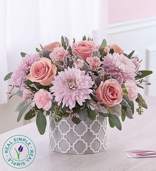 Pink roses and lavender daisies in a patterned vase