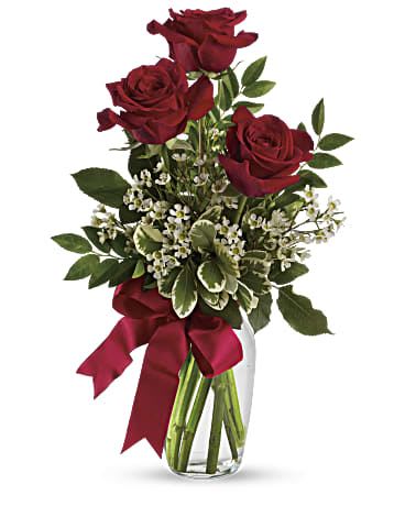 Thoughts of You Bouquet  - This charming bouquet includes three red roses accented with white waxflower, huckleberry and pittosporum along with a red satin ribbon. Available 3, 6, 12 roses Delivered in a clear glass vase. 