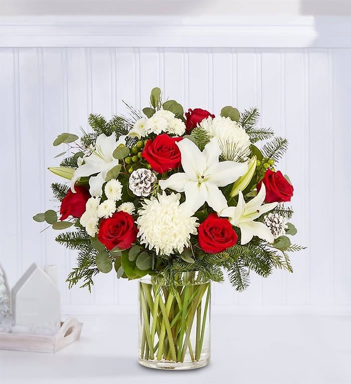 Red roses and white lilies in a clear glass vase