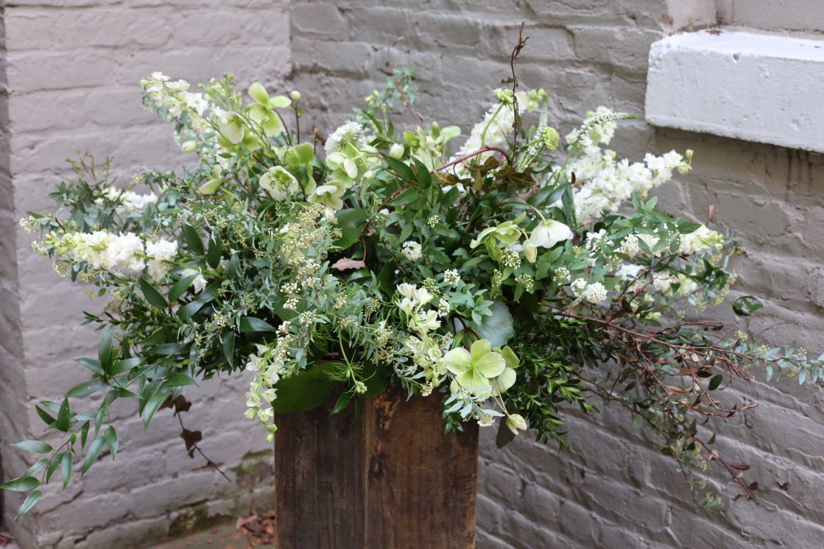 Funeral Casket Spray - An exquisite display of flowers to celebrate the life of your loved one.  Please let us know if have a preference for any specific colors or flower types. Measures approximately 20" long by 14" wide.  A special note: This arrangement is constructed with 100% compostable materials, such as basalt wool and palm leaves (in lieu of the typical floral foam and plastic liner). When available, we are happy to incorporate locally-farmed and harvested flowers as well. Thank you for supporting a more eco-friendly and sustainable option for funeral florals.