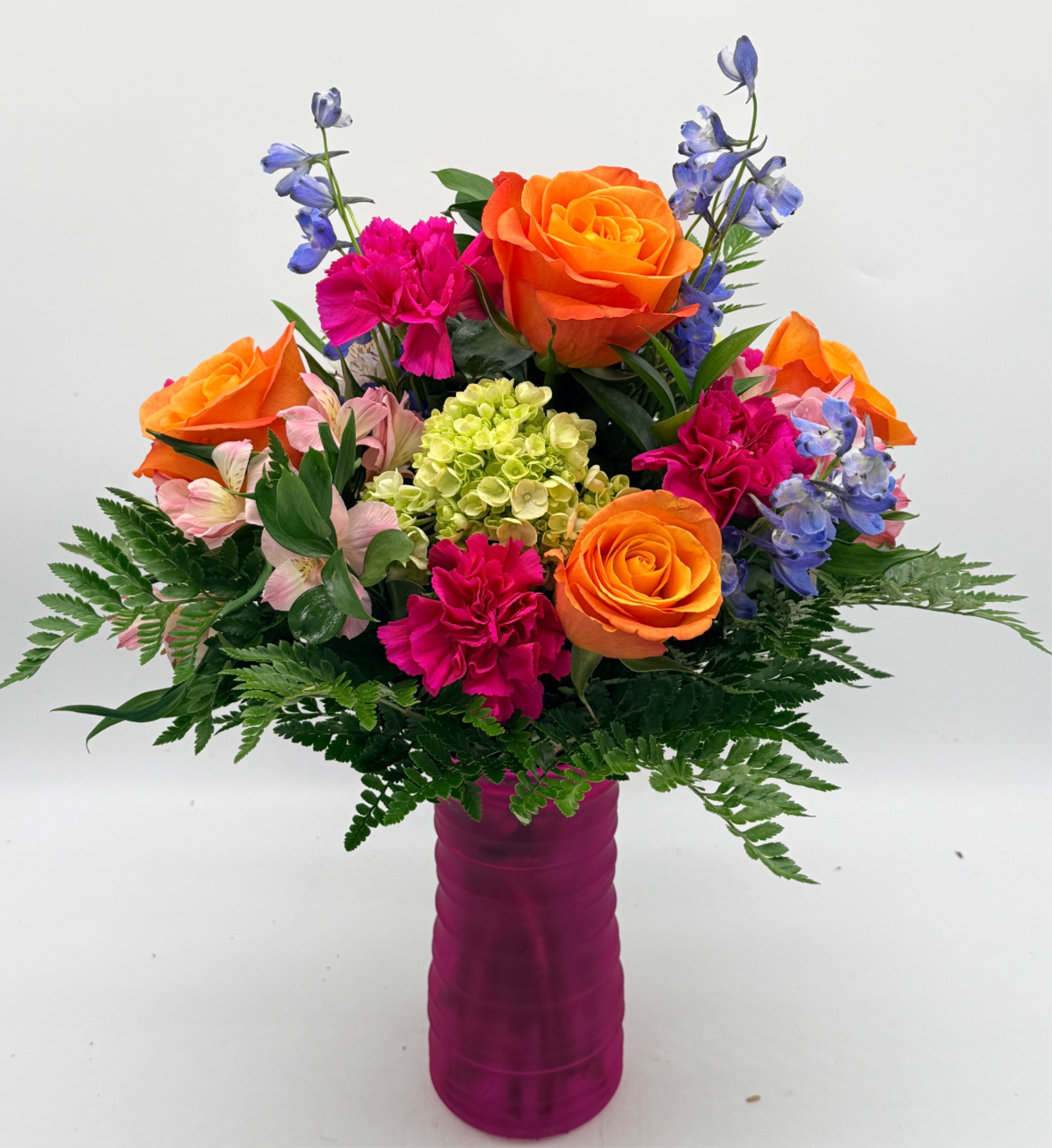 Tutti Frutti - Bright color pops make this mixed-color flower arrangement an instant mood lifter perfect as a birthday bouquet or an everyday celebration for someone who loves bold, playful blooms.