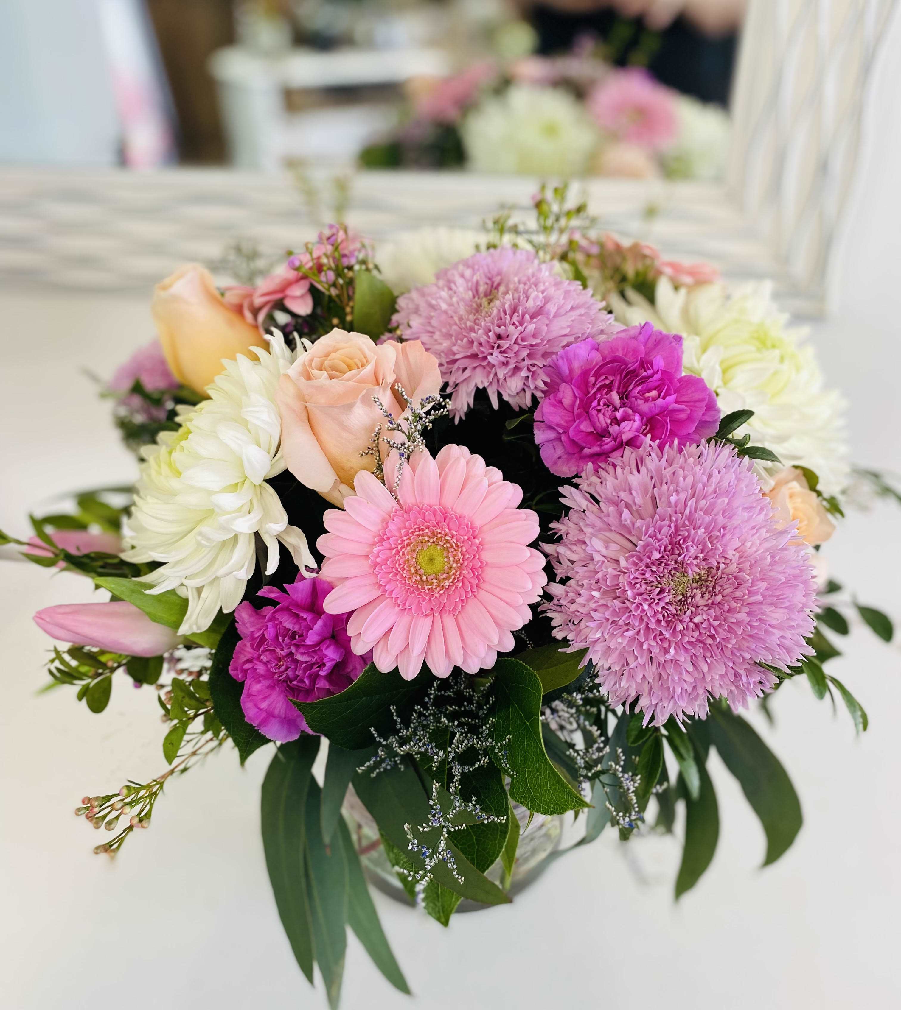 Pink and white mixed flower bouquet in a glass vase