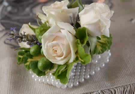 White Spray Rose Wrist Corsage #6 - This beautiful white spray rose wrist corsage can be made with a plain, rhinestone, or pearl wristlet. Boutonnieres and corsages can be made with any color accent and ribbon. Please call us for more information or specify colours of outfit/dress in the "Florists' Instructions" section of the check out page.