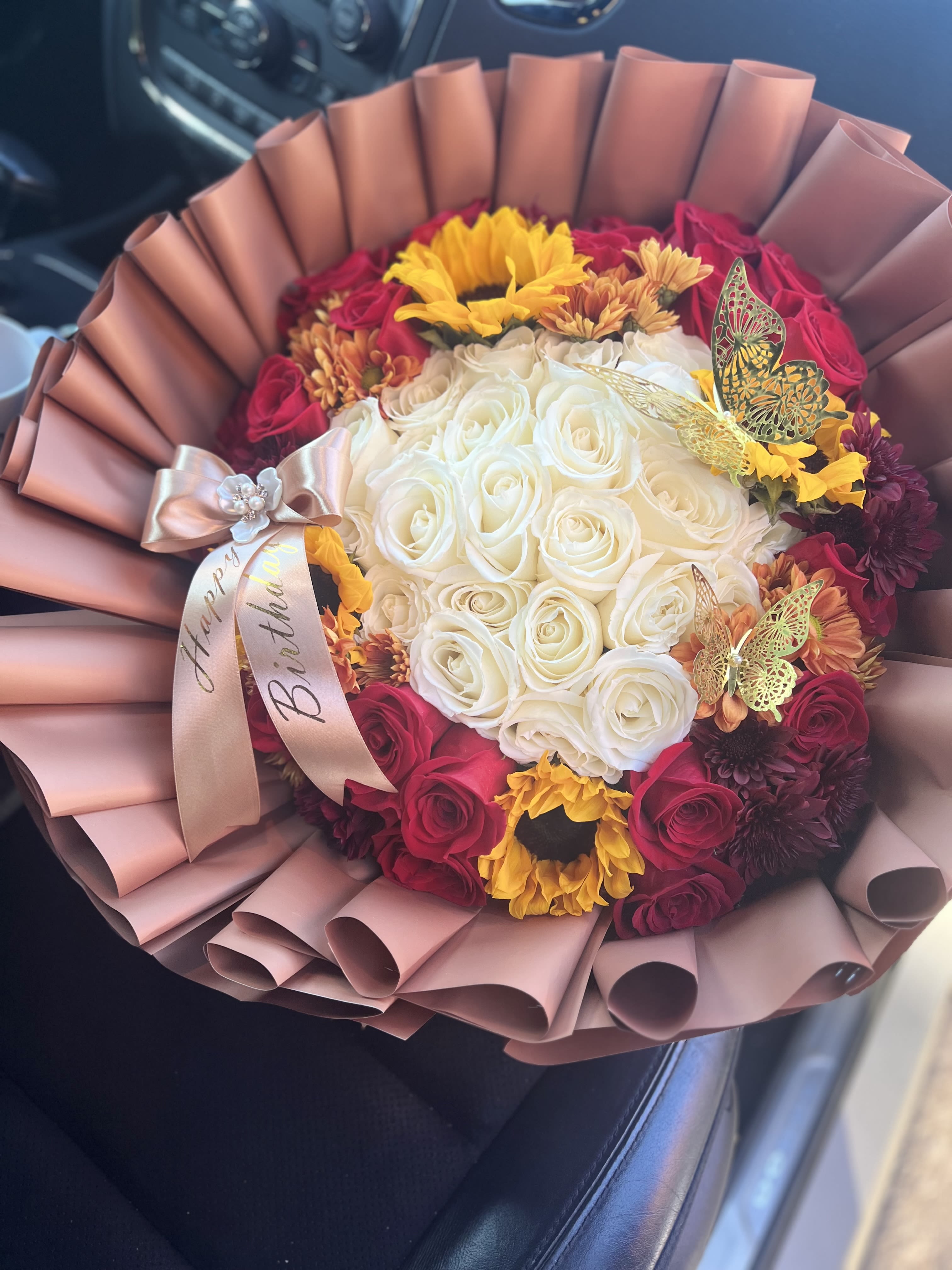 Bouquet of white and red roses with sunflowers and a birthday ribbon