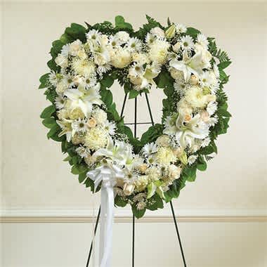 Always Remember™ Floral Heart Tribute- White - The enduring love you feel for them will keep them always remembered. This sentiment is best captured with our standing, open heart-shaped arrangement in all white. Handcrafted by our caring florists with an assortment of flawless white blooms, it is a magnificent tribute fitting for the funeral services. •Open, heart-shaped arrangement of all white roses, hybrid lilies, football mums, carnations and daisy poms; accented with baby’s breath and soft, lush greenery •Arrangement is designed on an easel and accented with satin ribbon •Measures approximately 26"H x 28"W without easel •Appropriate for the funeral home •Our florists use only the freshest flowers available, so colors and varieties may vary