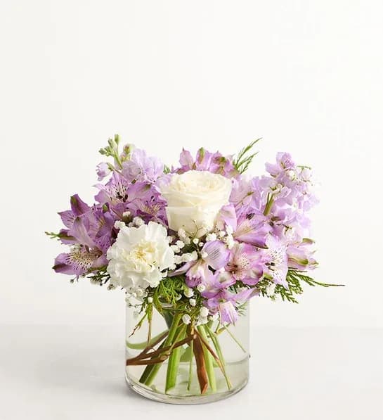 Lavender and white bouquet in a clear glass vase