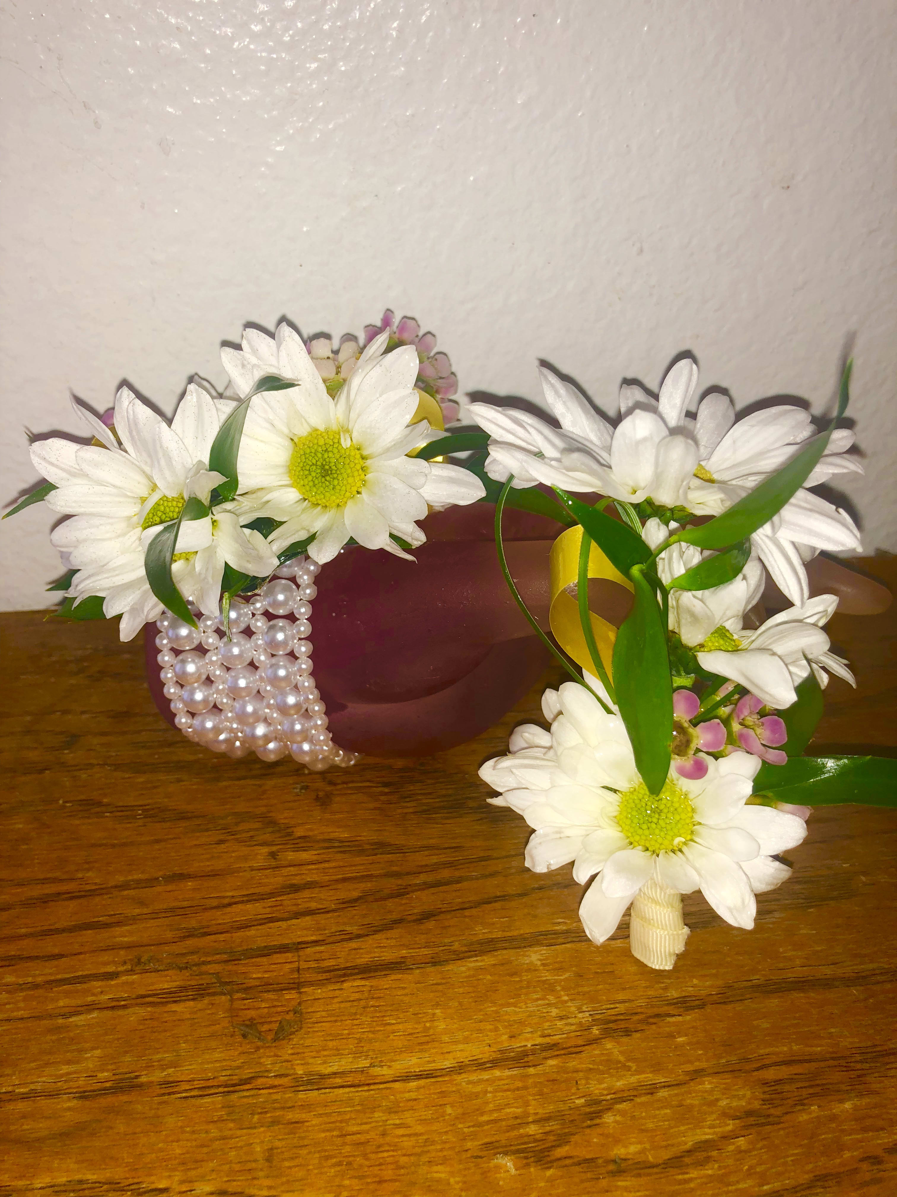 White daisy corsages with green ribbon and pearl accents