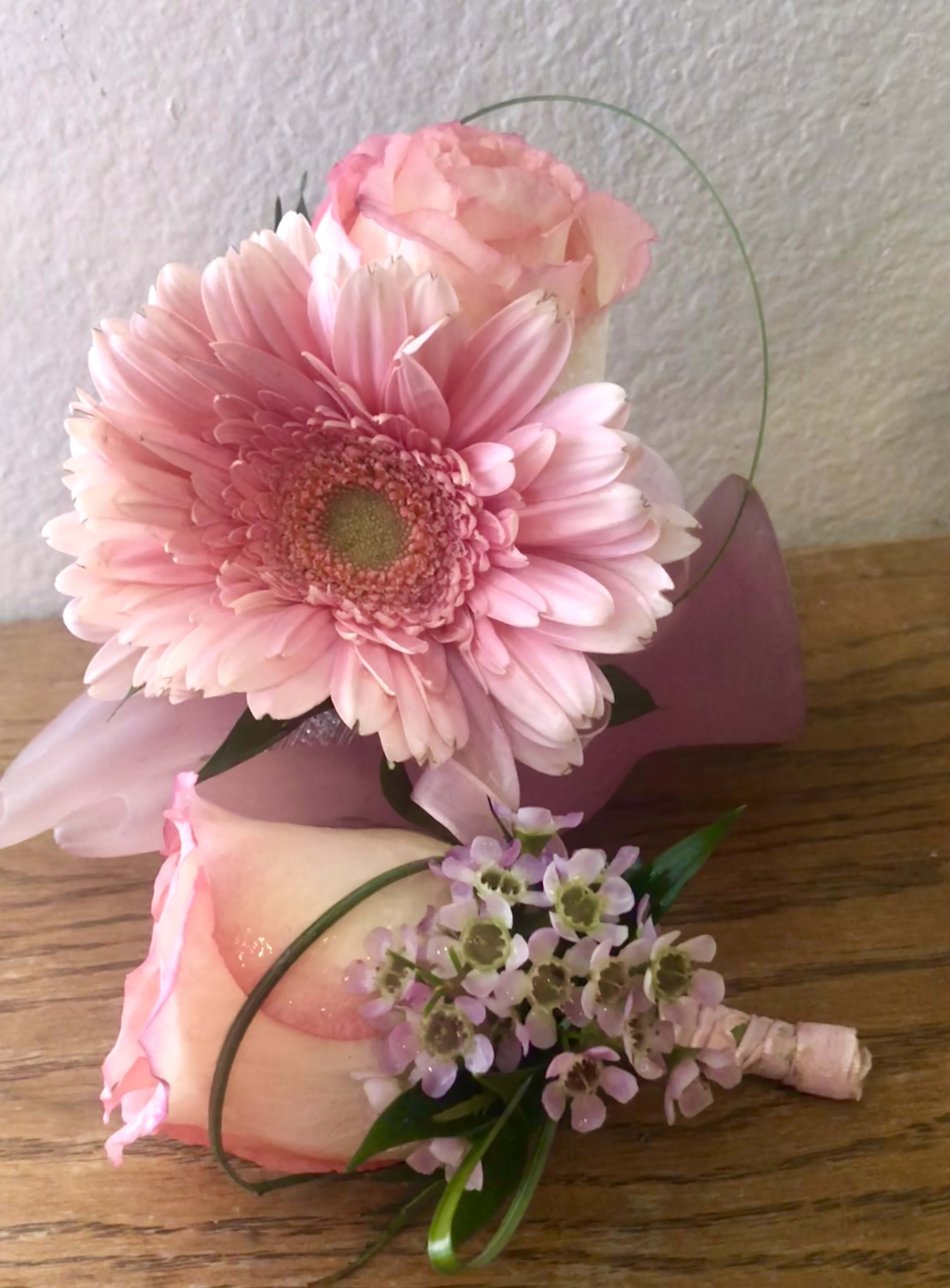 Pink gerbera daisy bouquet with a rose boutonniere