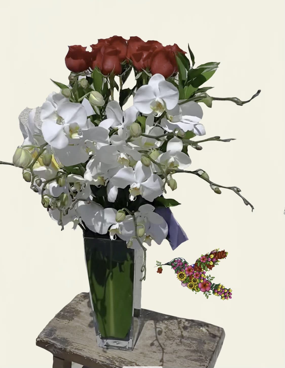 Red roses and white orchids in a tall glass vase