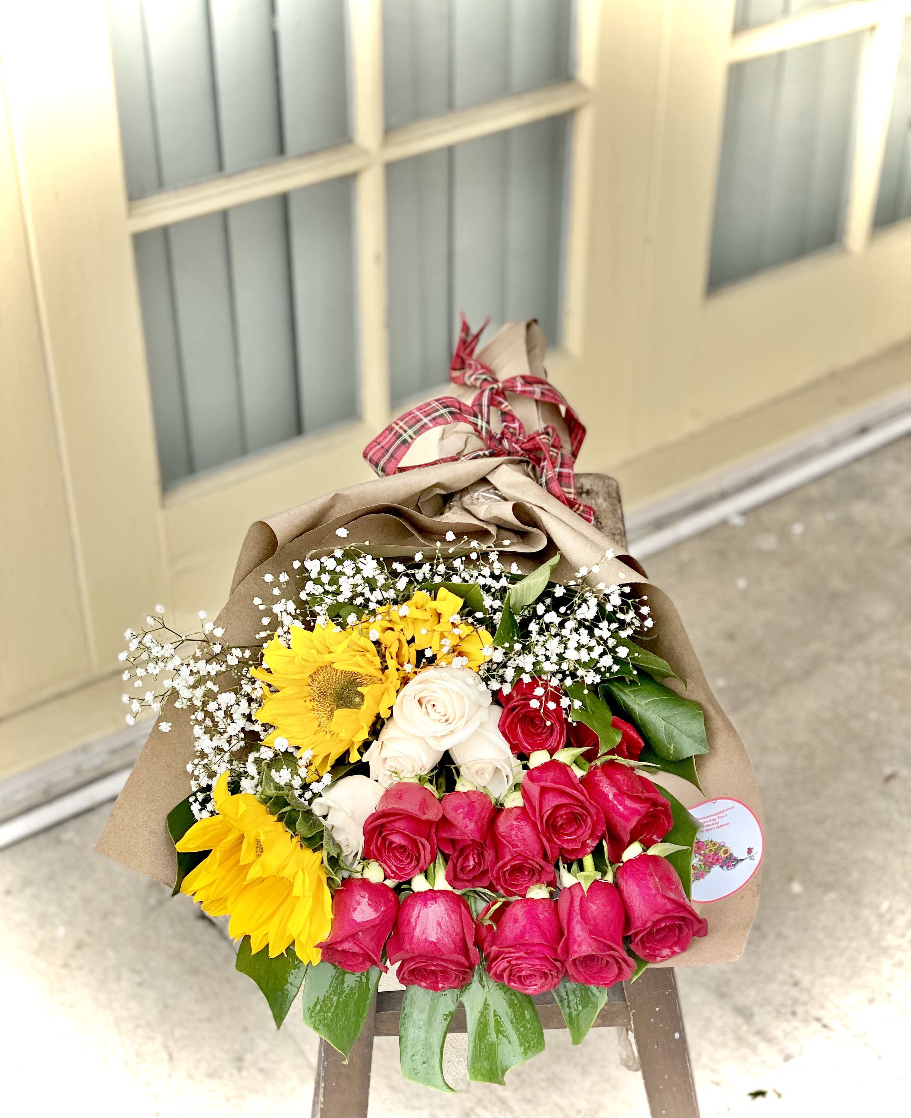 Bouquet of red, white, and yellow roses with sunflowers