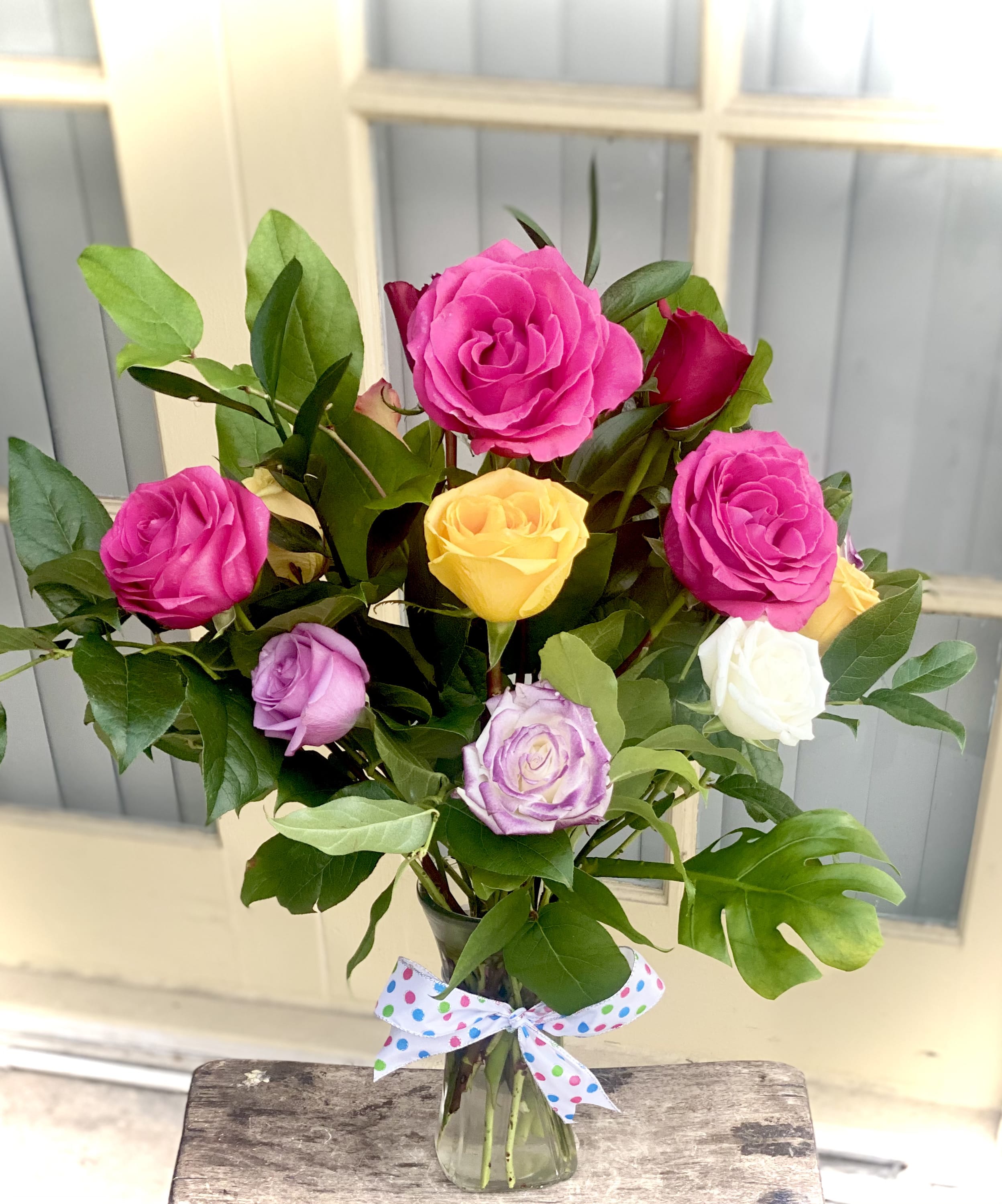 One Dozen Assorted Mix  Short Stem Roses  - Send one dozen assorted mix short stem rose bouquet. Delivered with seasonal roses in a variety of colors including hot pink, purple, red and yellow.
