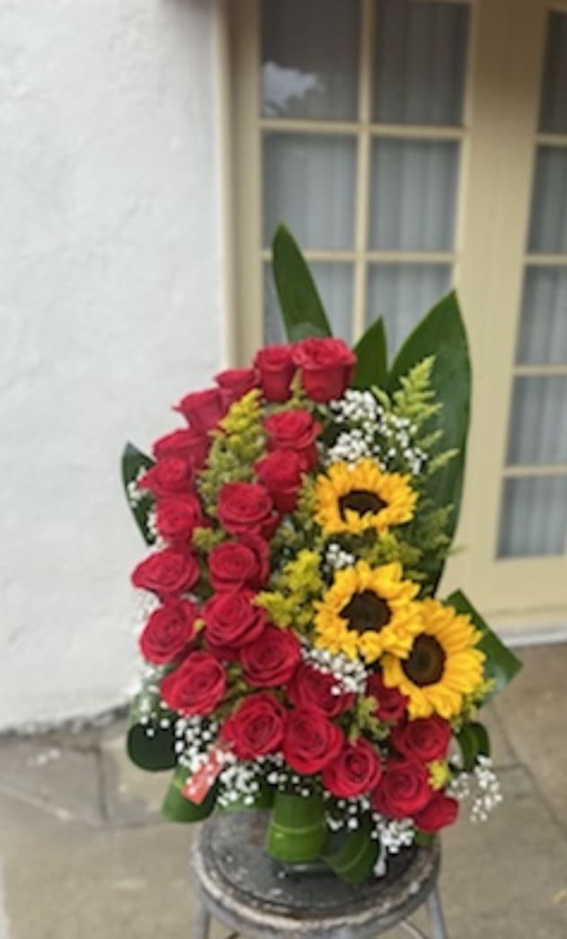 Bouquet of red roses and sunflowers with white filler flowers
