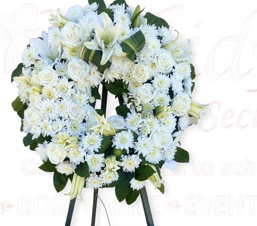 White floral wreath on a standing easel