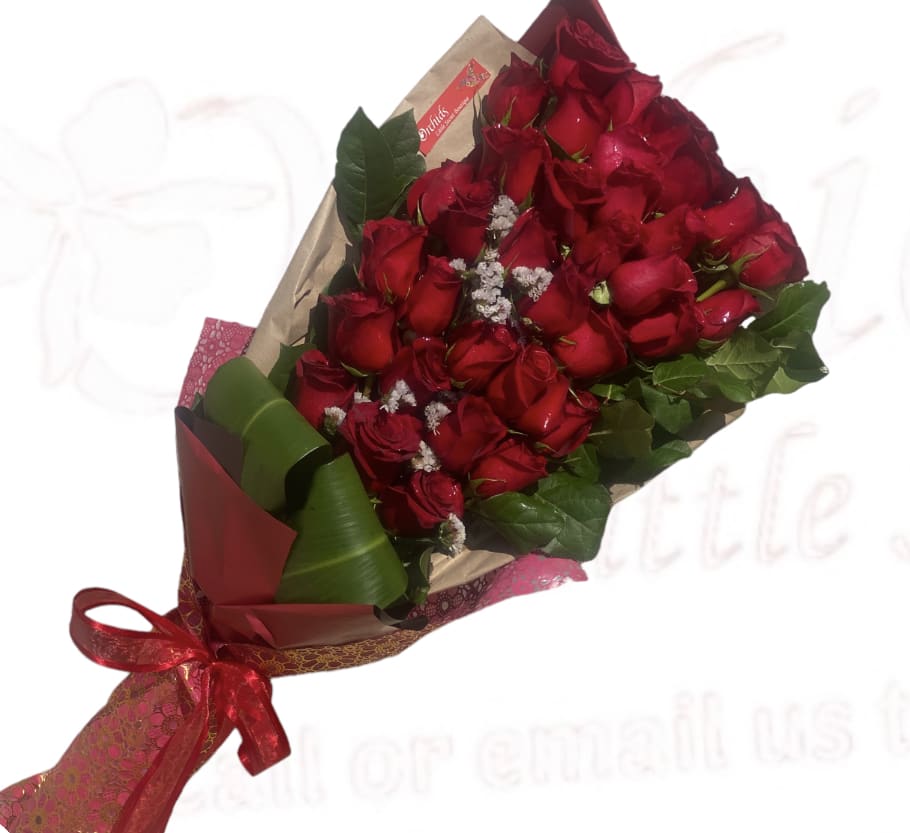 Bouquet of red roses wrapped in paper with a red ribbon