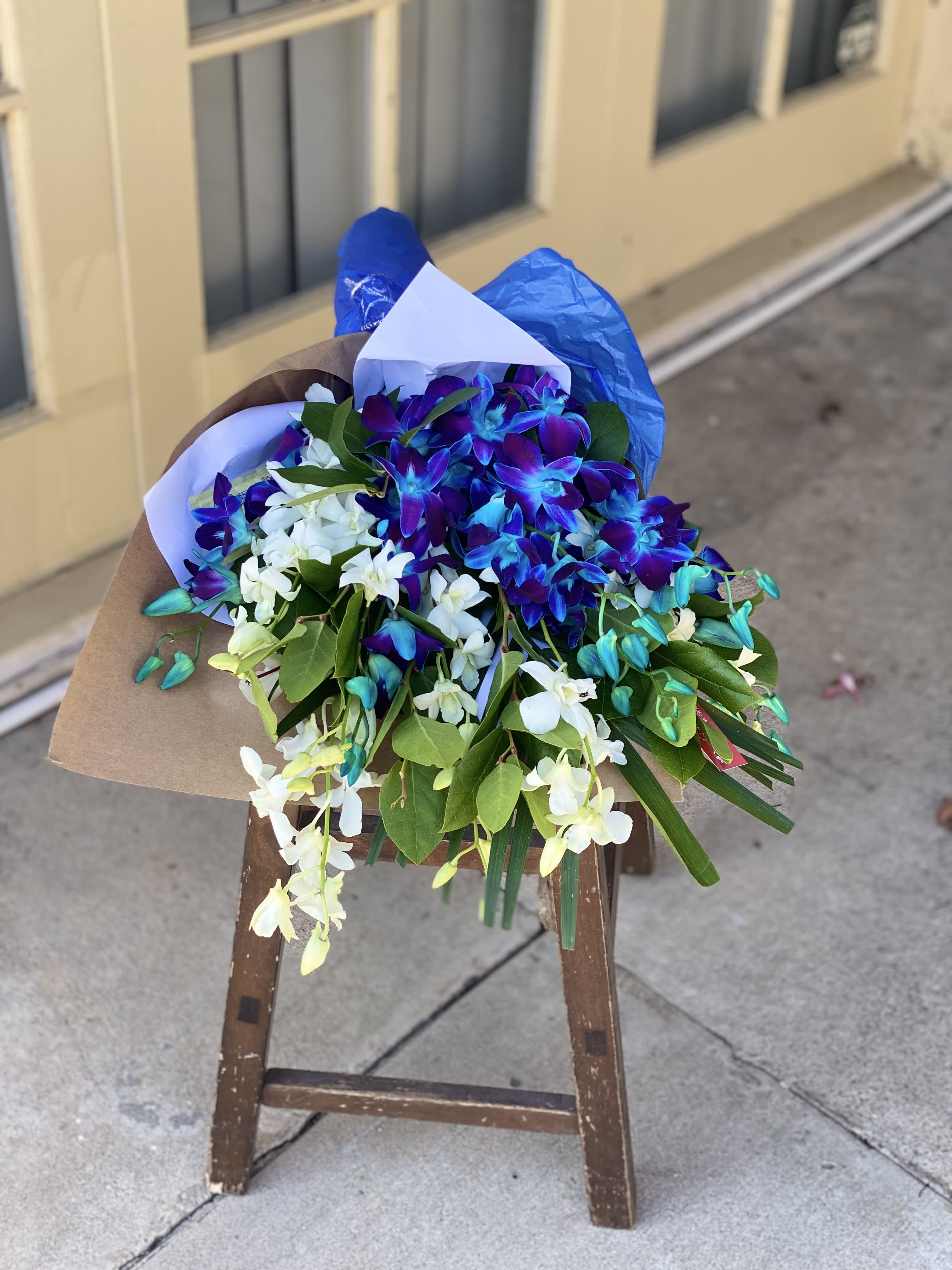 Bouquet of blue and white orchids wrapped in paper