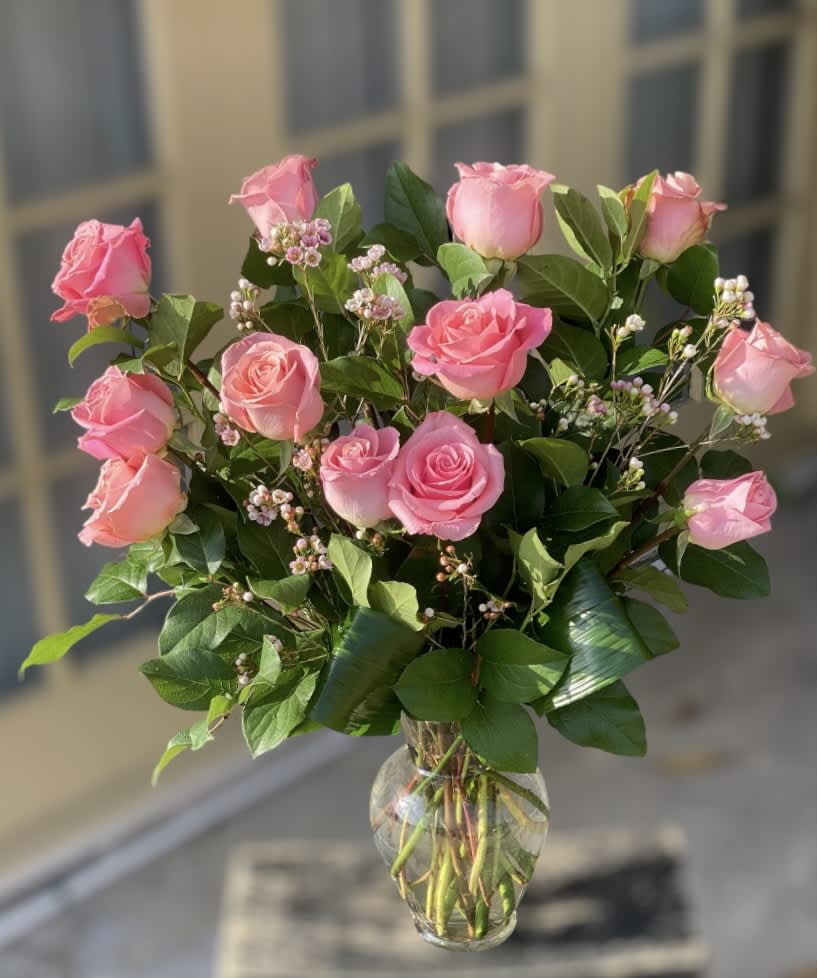 Pink roses arranged in a clear glass vase