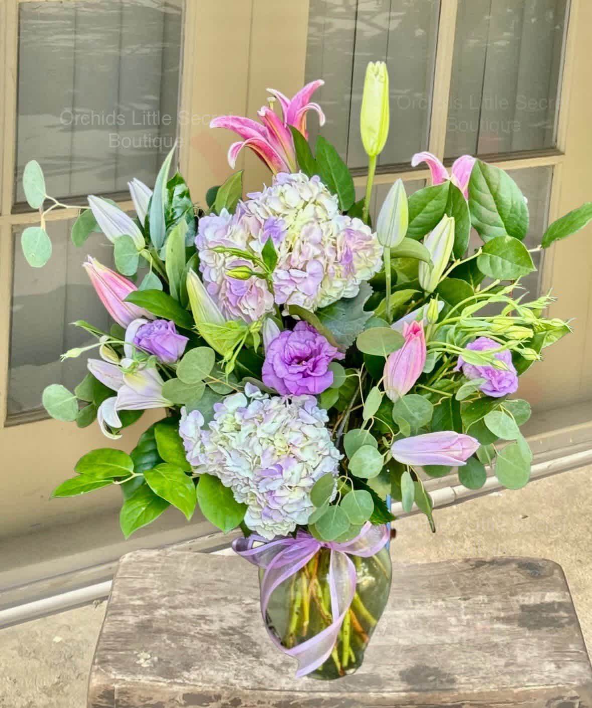 Lavender and pink bouquet with lilies and hydrangeas in a glass vase