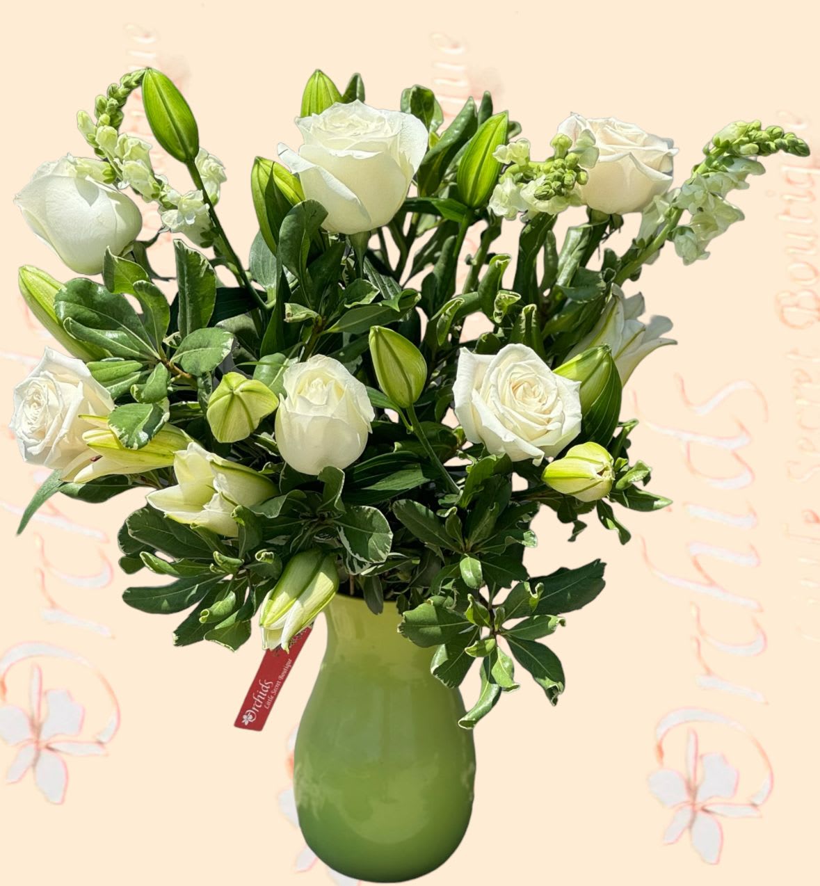 White roses and lily buds in a green vase