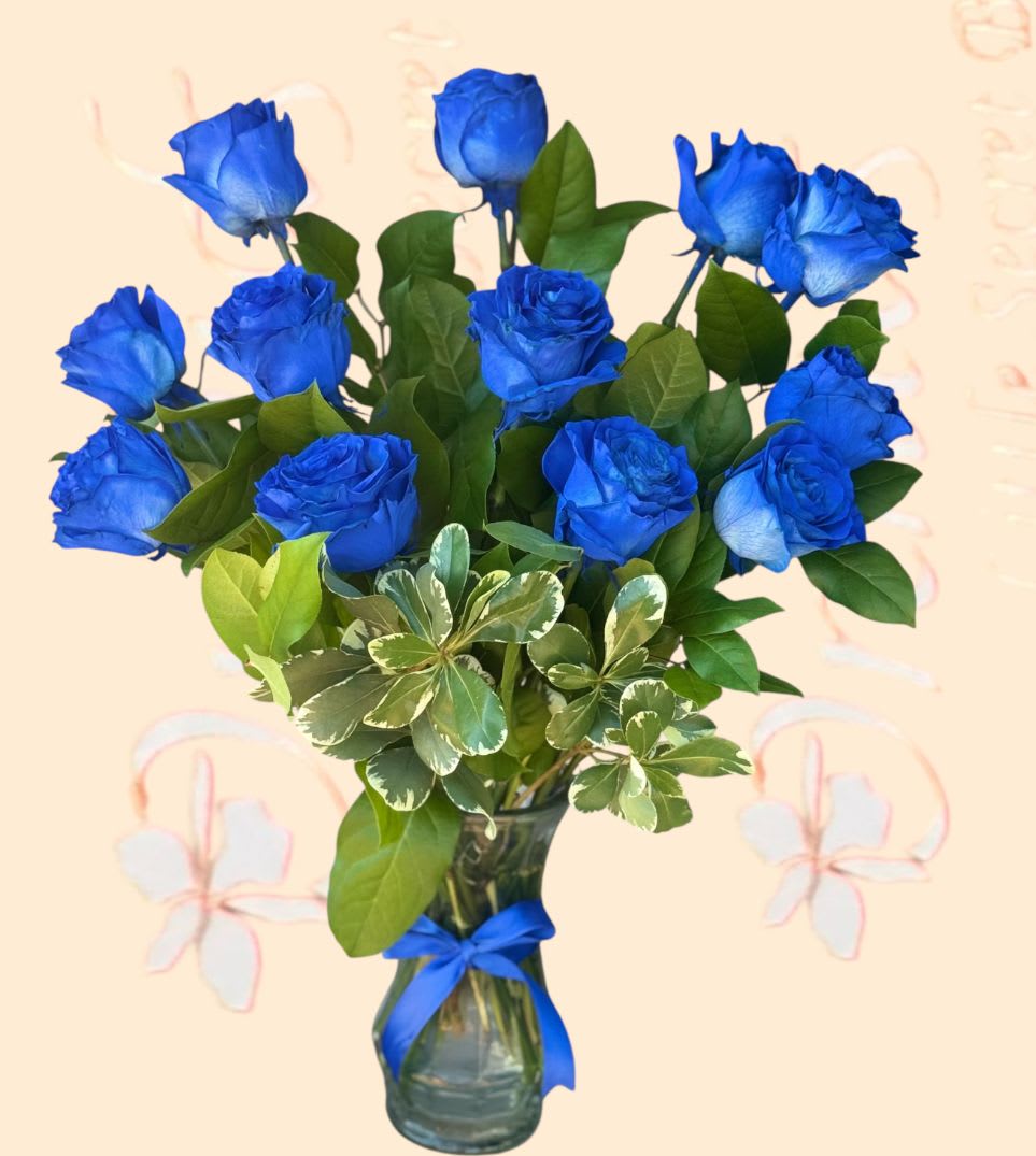 Blue roses in a glass vase with a ribbon