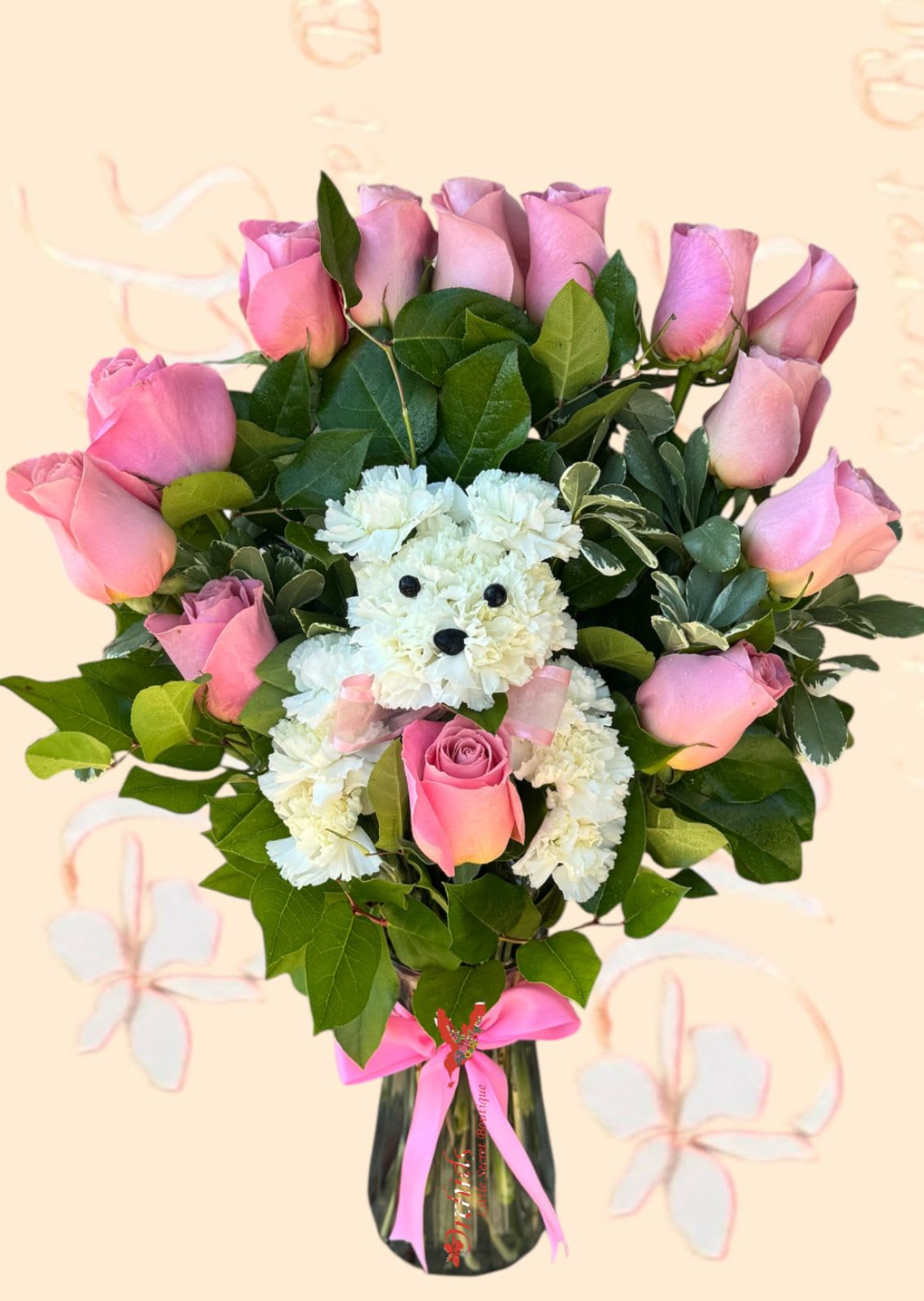 Pink roses and a white teddy bear made of carnations in a glass vase