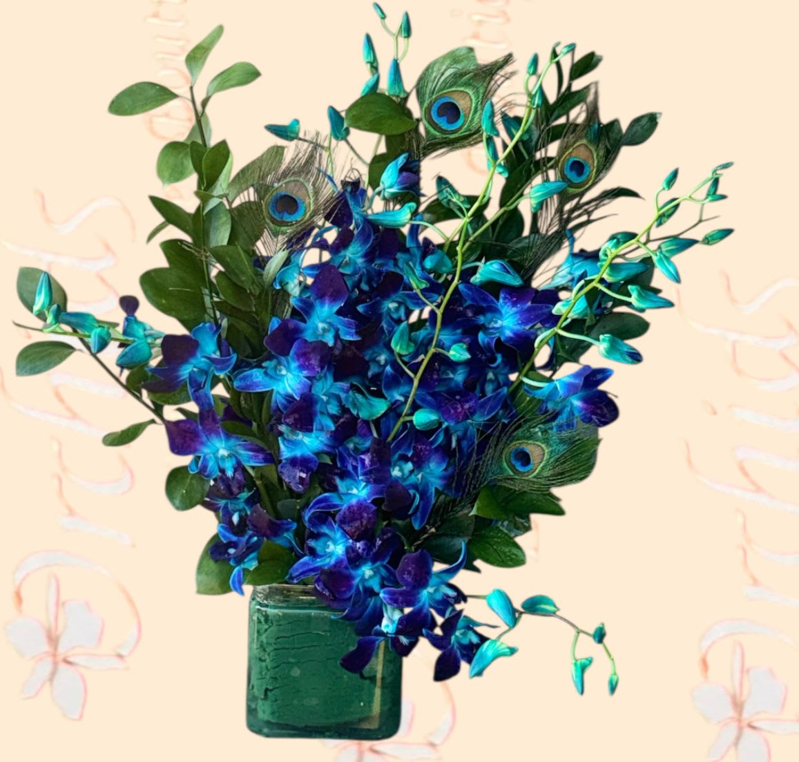 Blue orchids and peacock feathers in a green glass vase