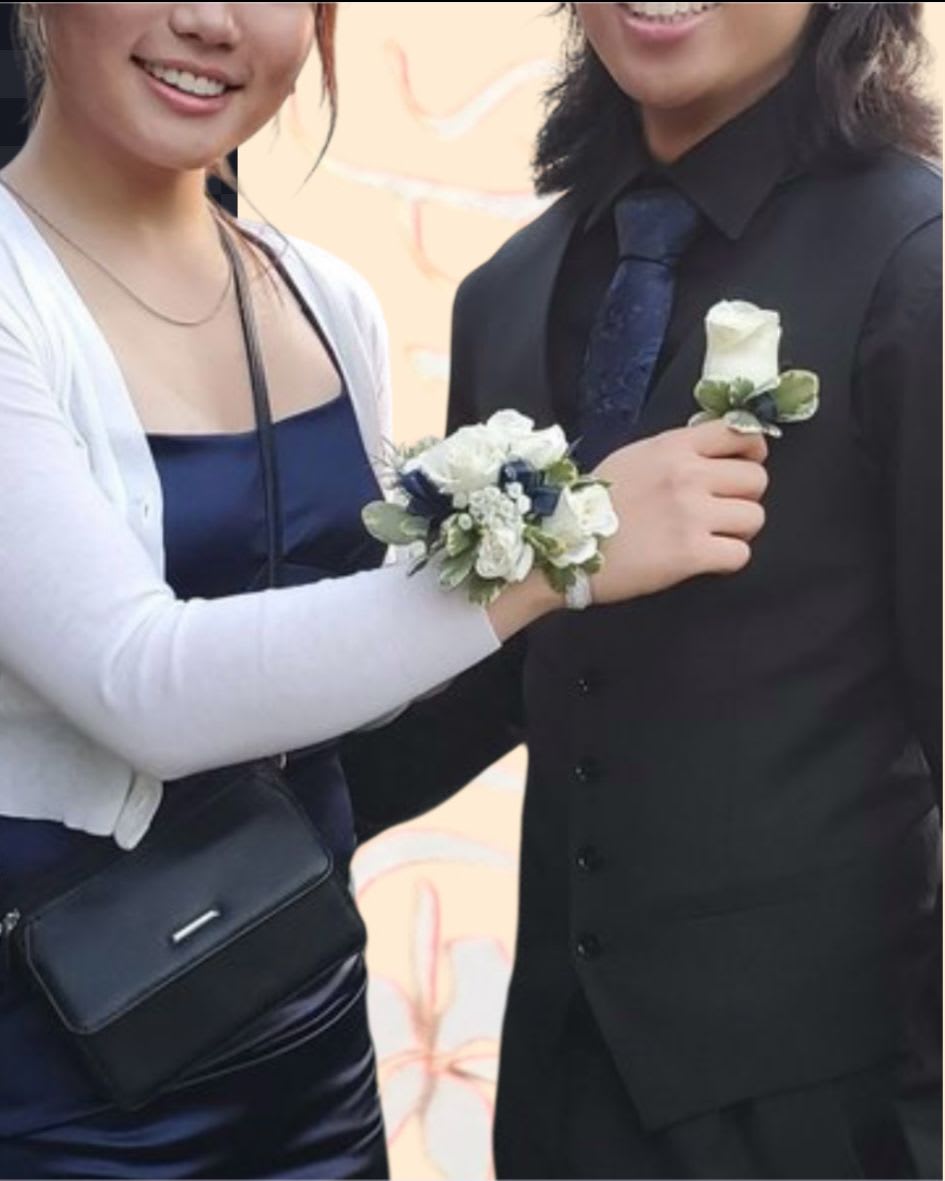 Couple wearing white rose corsage and boutonniere