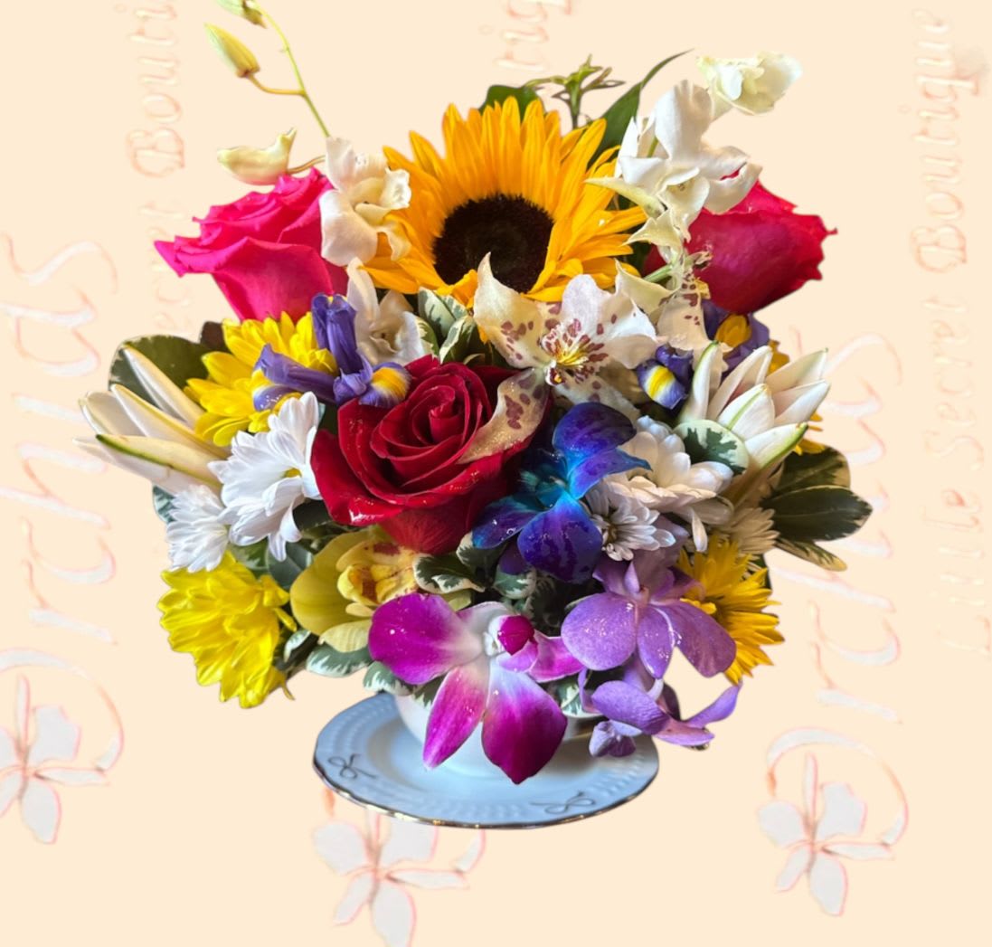 Colorful mixed bouquet with a sunflower, roses, and orchids in a vase