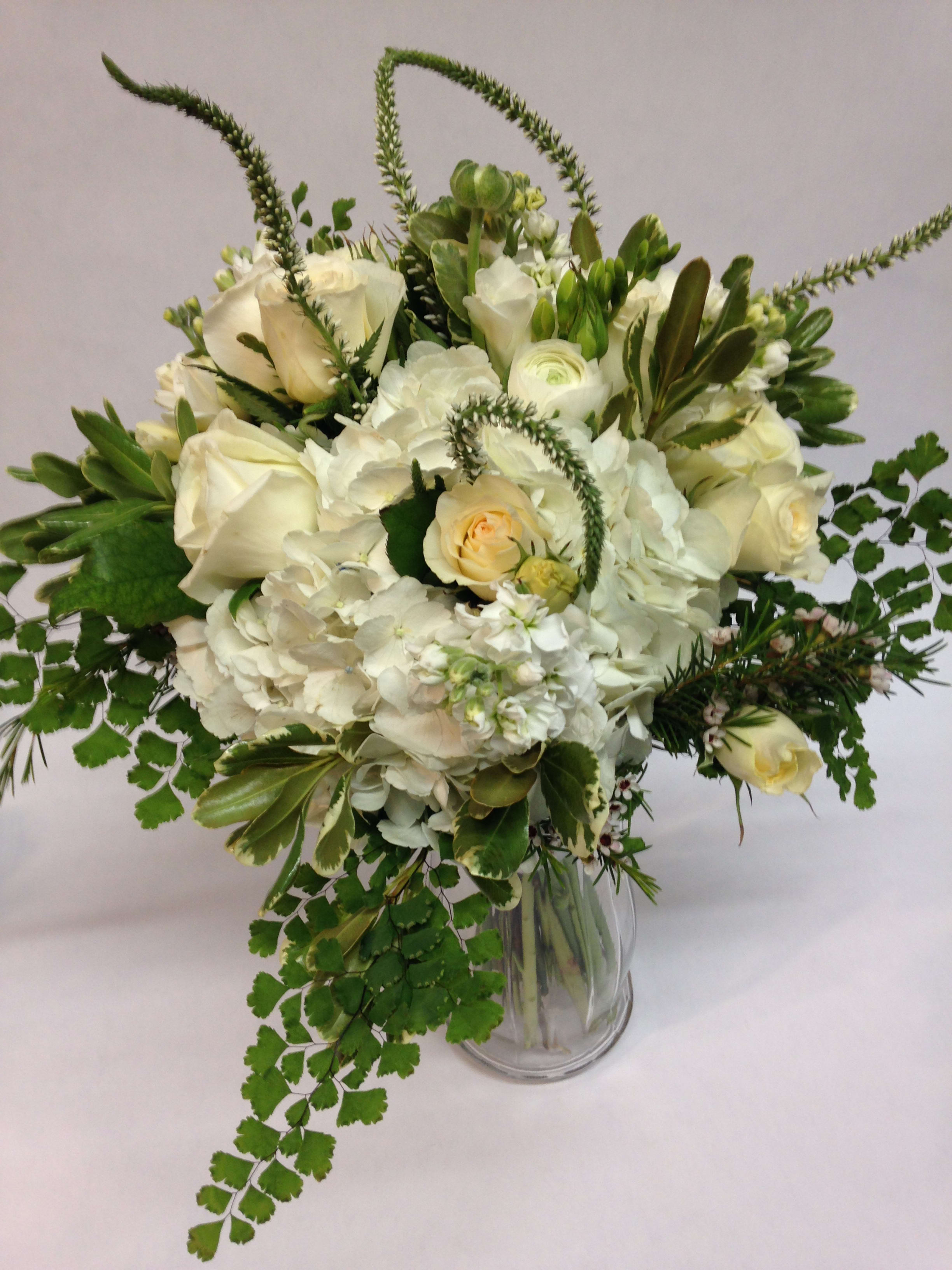 White and cream floral arrangement in a clear glass vase