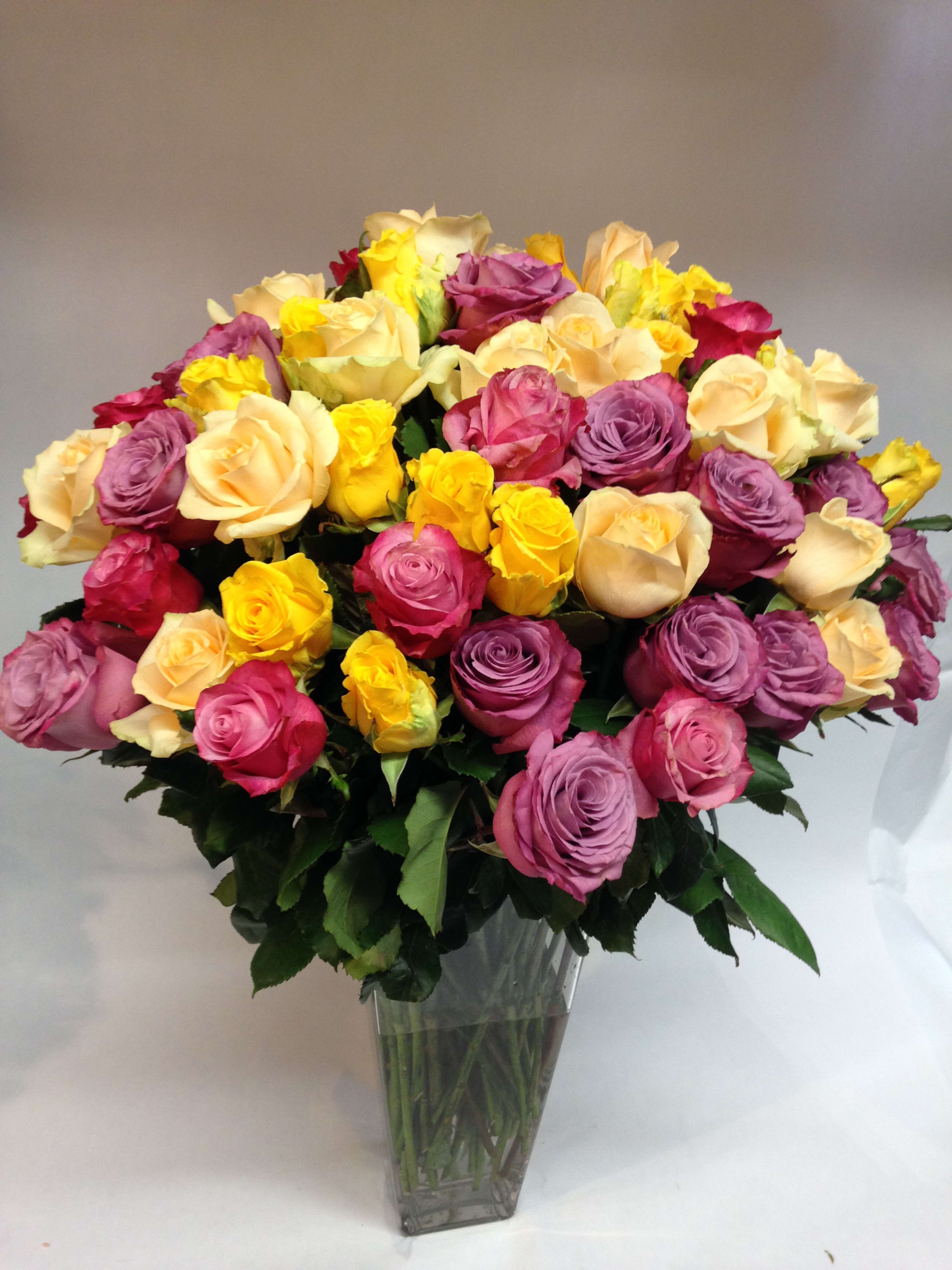 Mixed-color rose bouquet in a clear glass vase