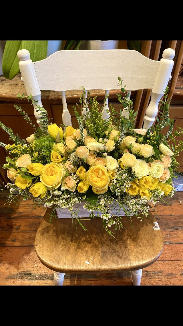 Yellow and cream floral arrangement on a chair