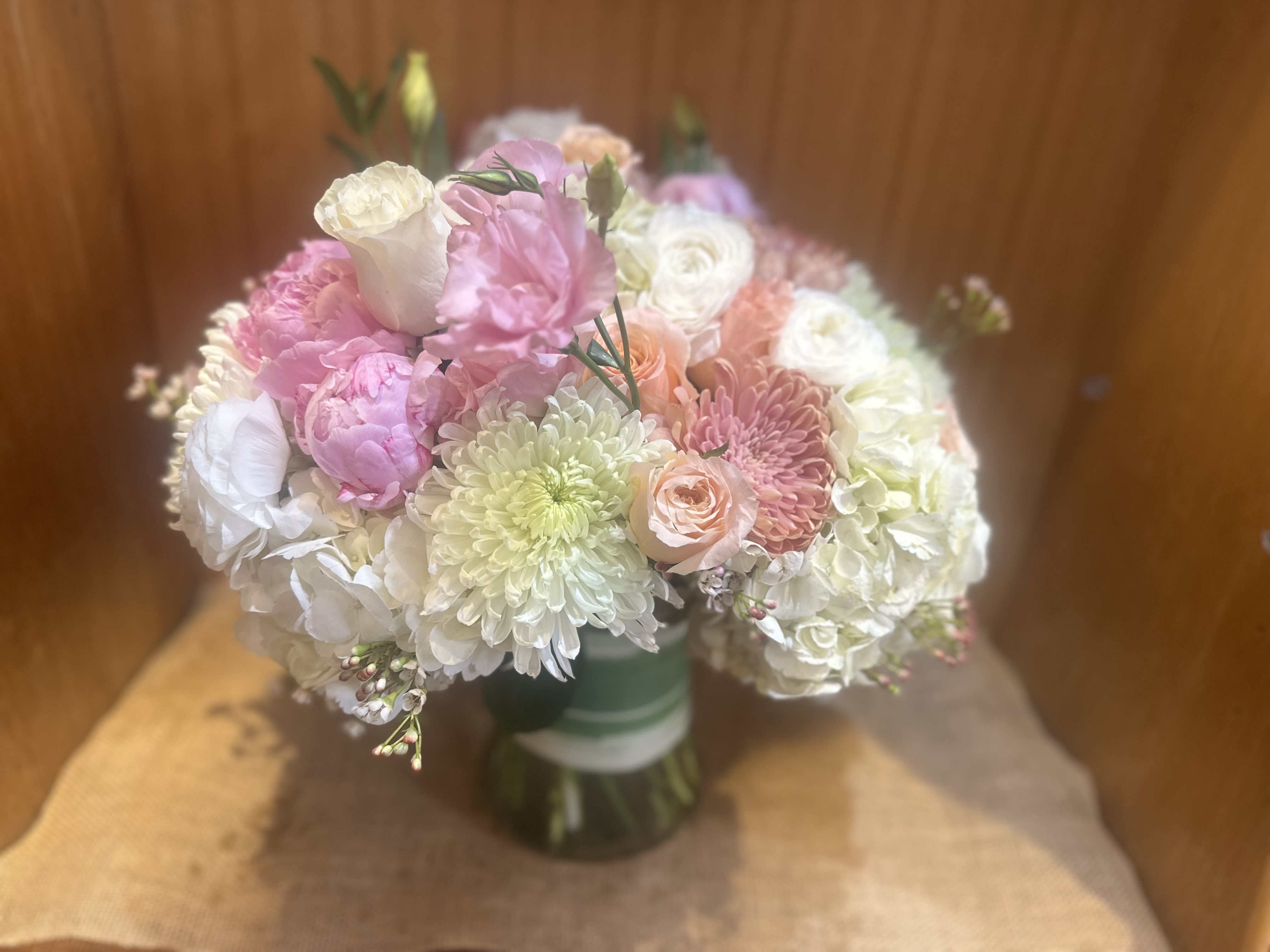 Bouquet of pink, white, and peach flowers in a glass vase