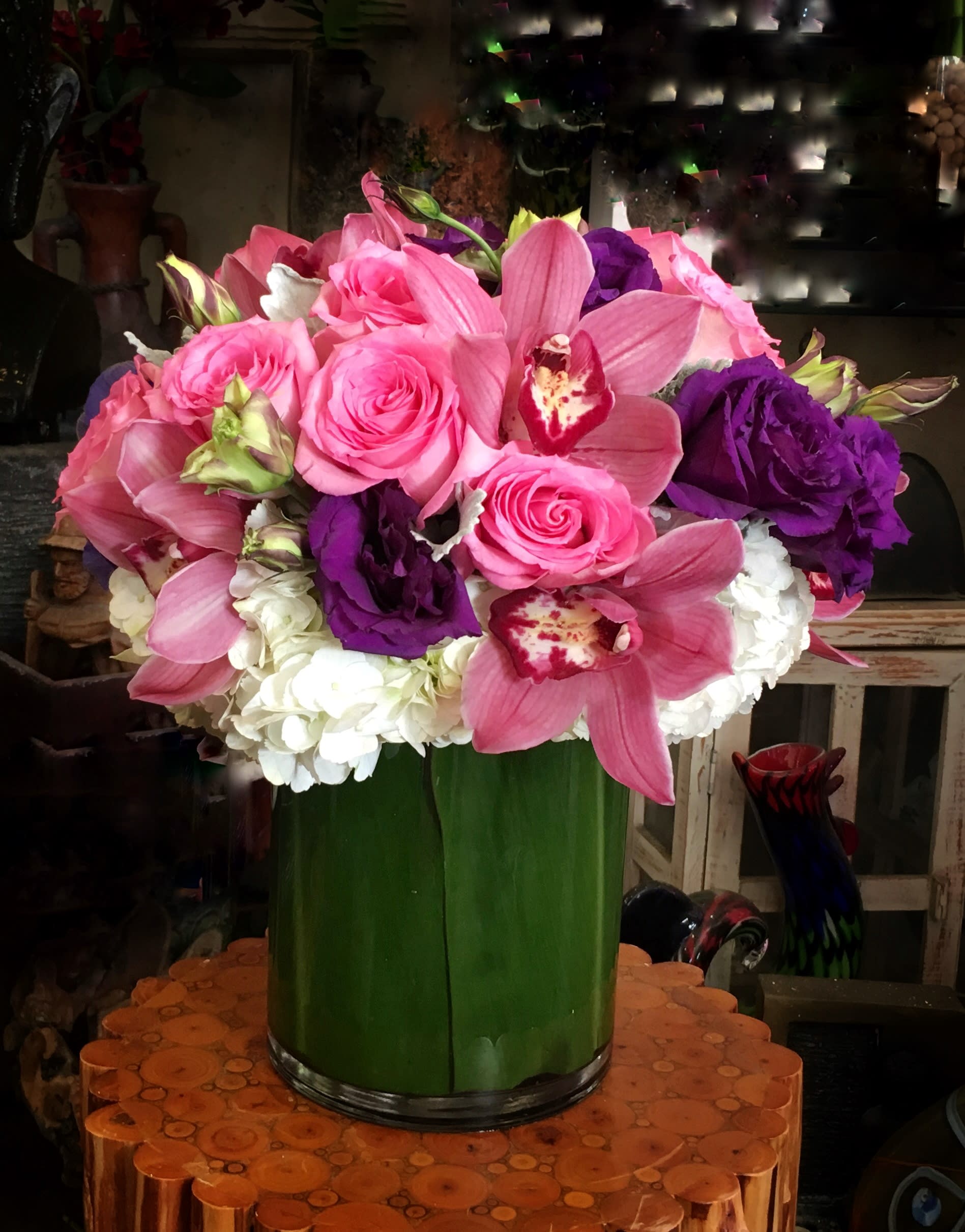 Pink and purple flower arrangement in a green vase
