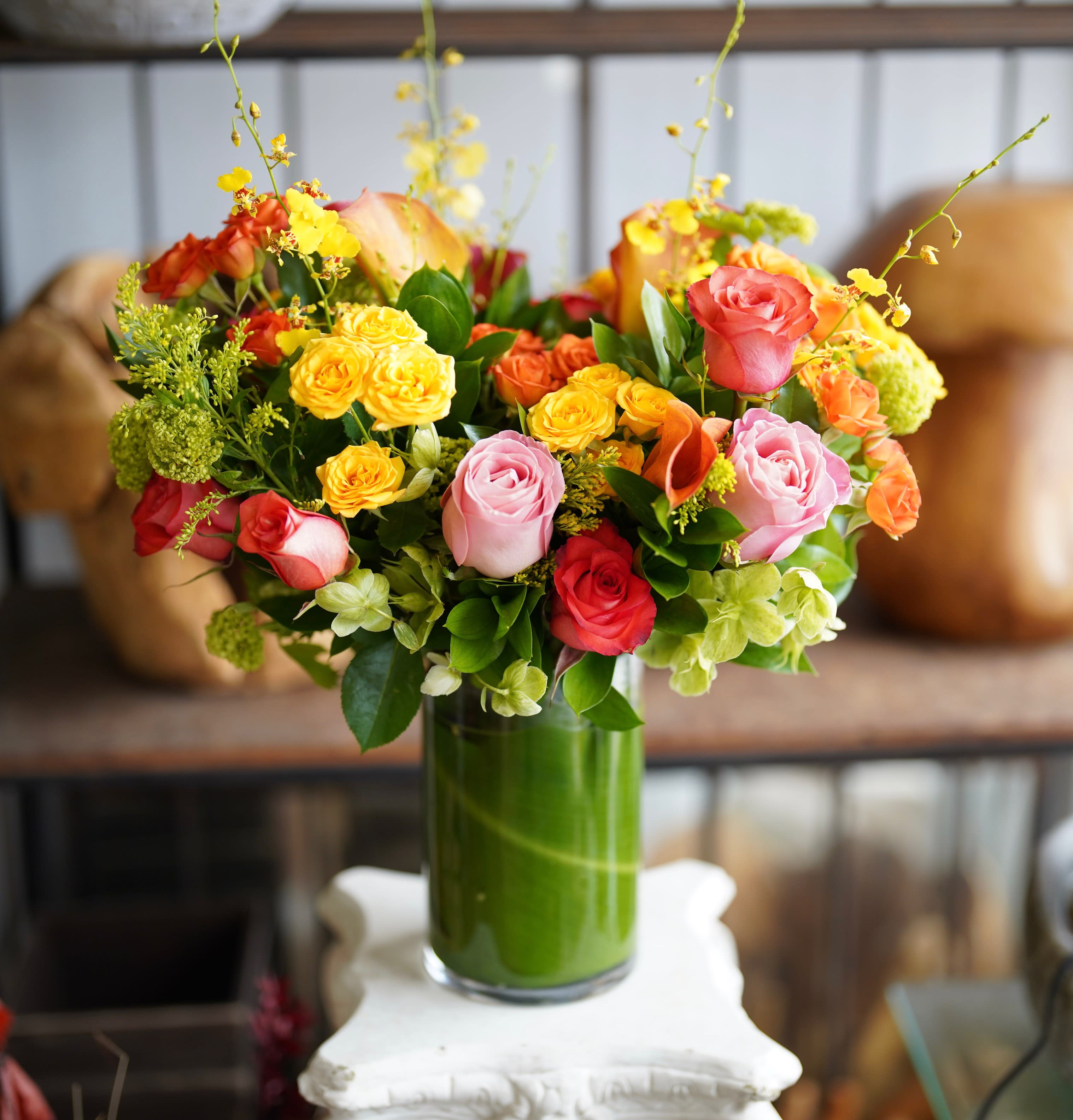 Colorful rose bouquet in a tall glass vase