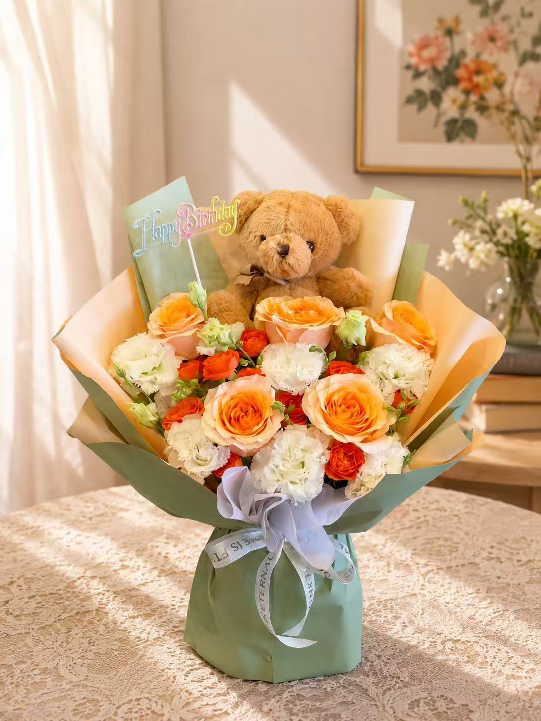 Bouquet of orange and white roses with a teddy bear and Happy Birthday topper